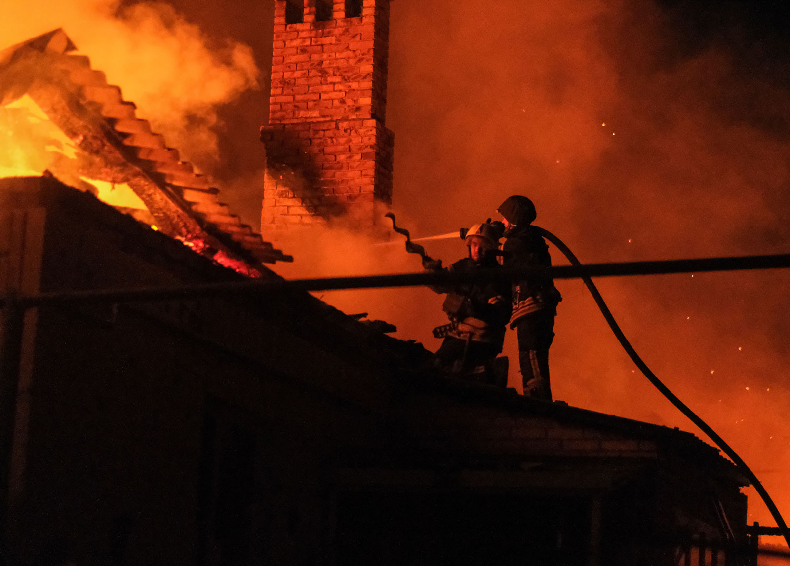 Ukrainian firefighters put out fire in a residential house after a Russian military strike in Bakhmut, Donetsk region, on Monday.