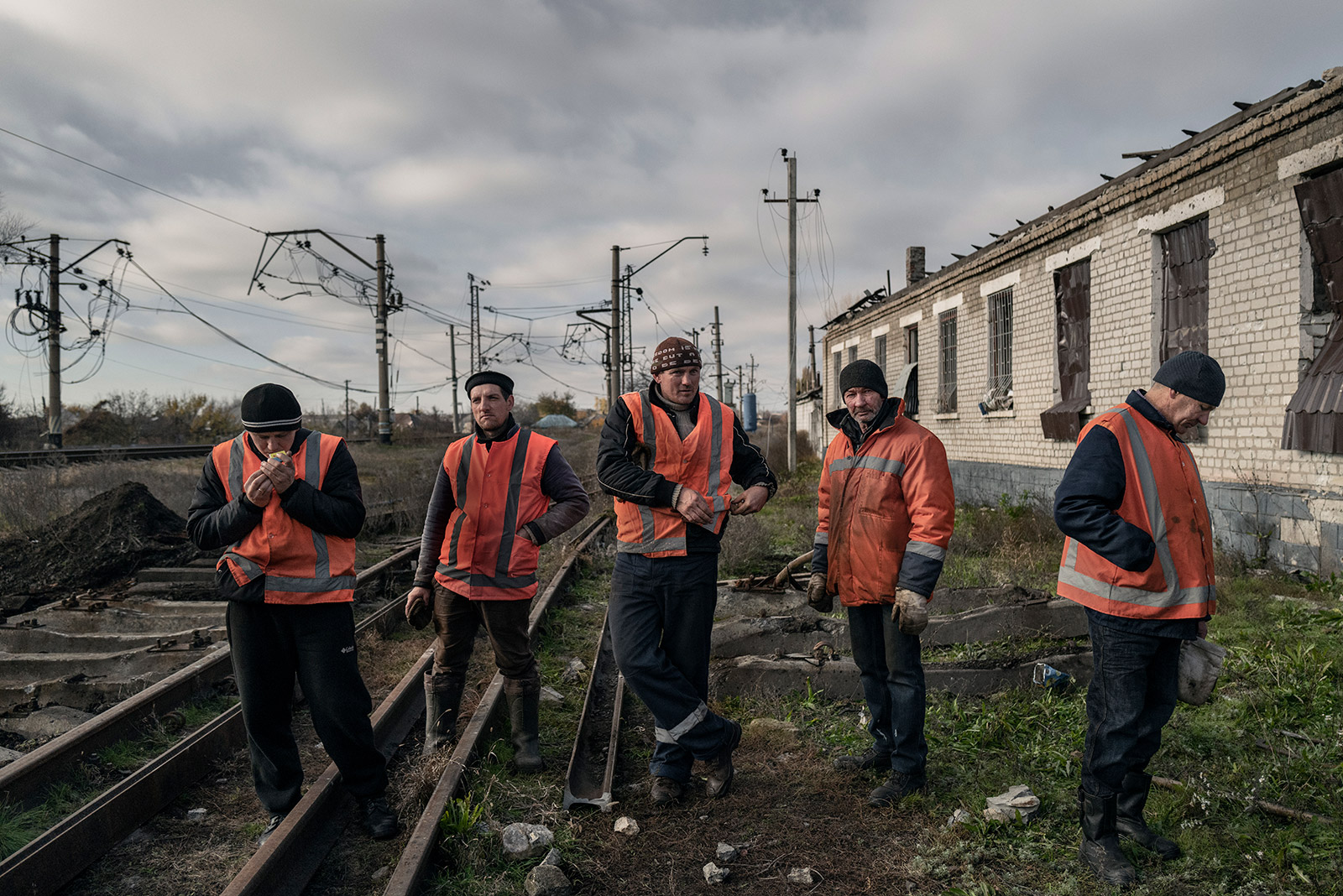 Railway workers look to repair a stretch of tracks that was damaged by shelling the day before. 