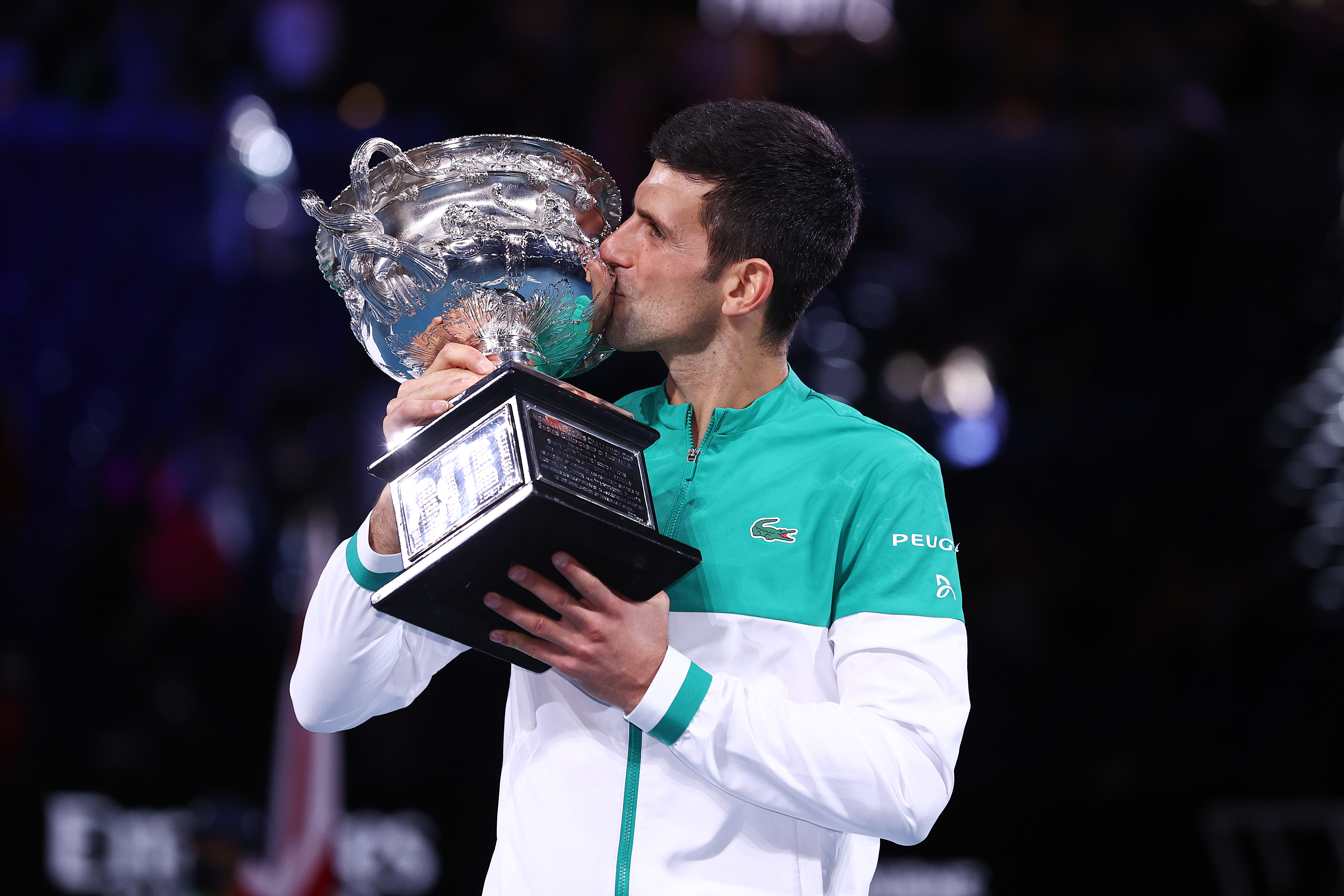 Novak Djokovic of Serbia holds the Norman Brookes Challenge Cup as he celebrates victory in his Men’s Singles Final match against Daniil Medvedev of Russia during day 14 of the 2021 Australian Open at Melbourne Park on February 21, 2021 in Melbourne, Australia. 