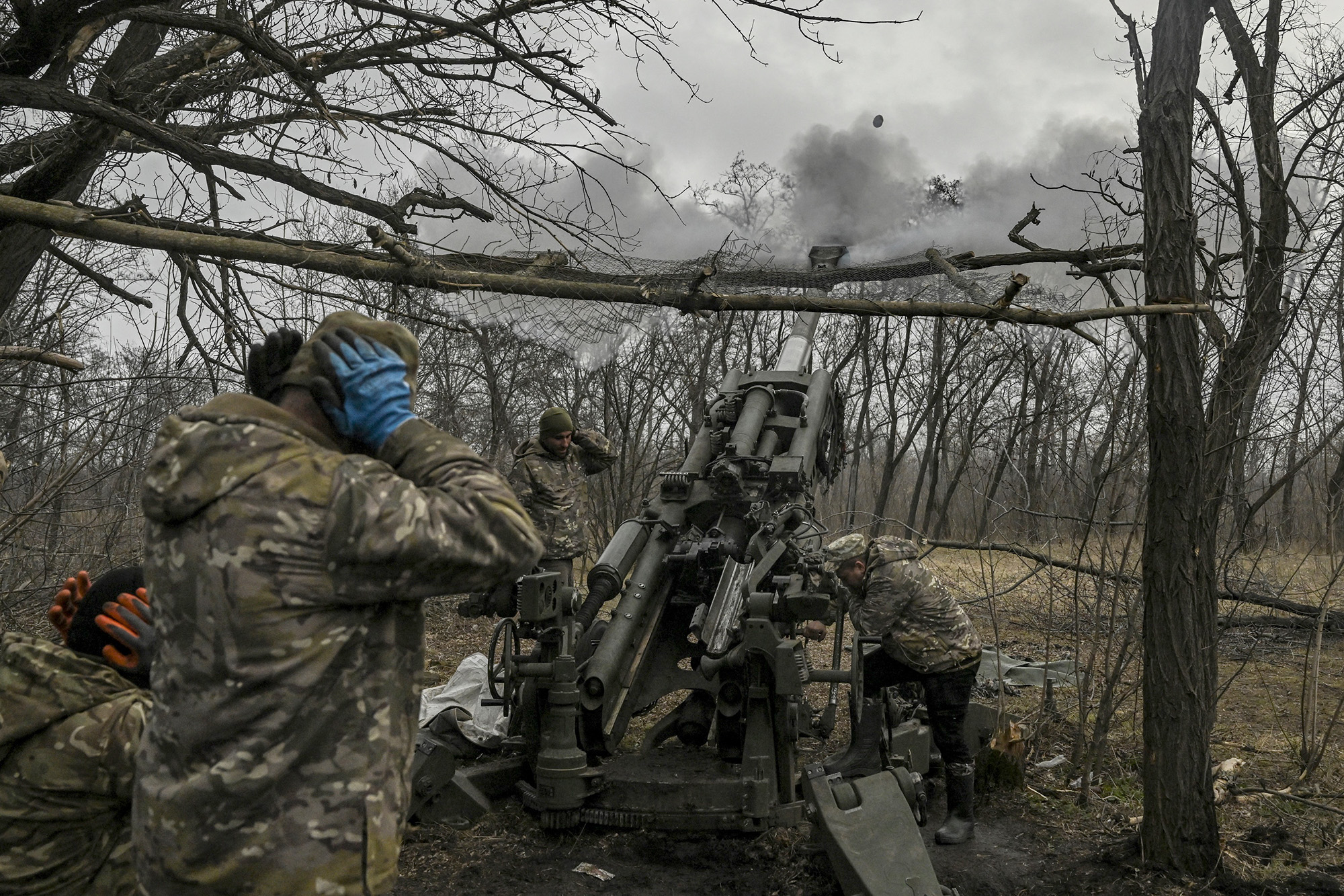 Ukrainian servicemen fire towards Russian positions with a 155mm M777 Howitzer artillery weapon on the front line near the city of Bakhmut on March 11.