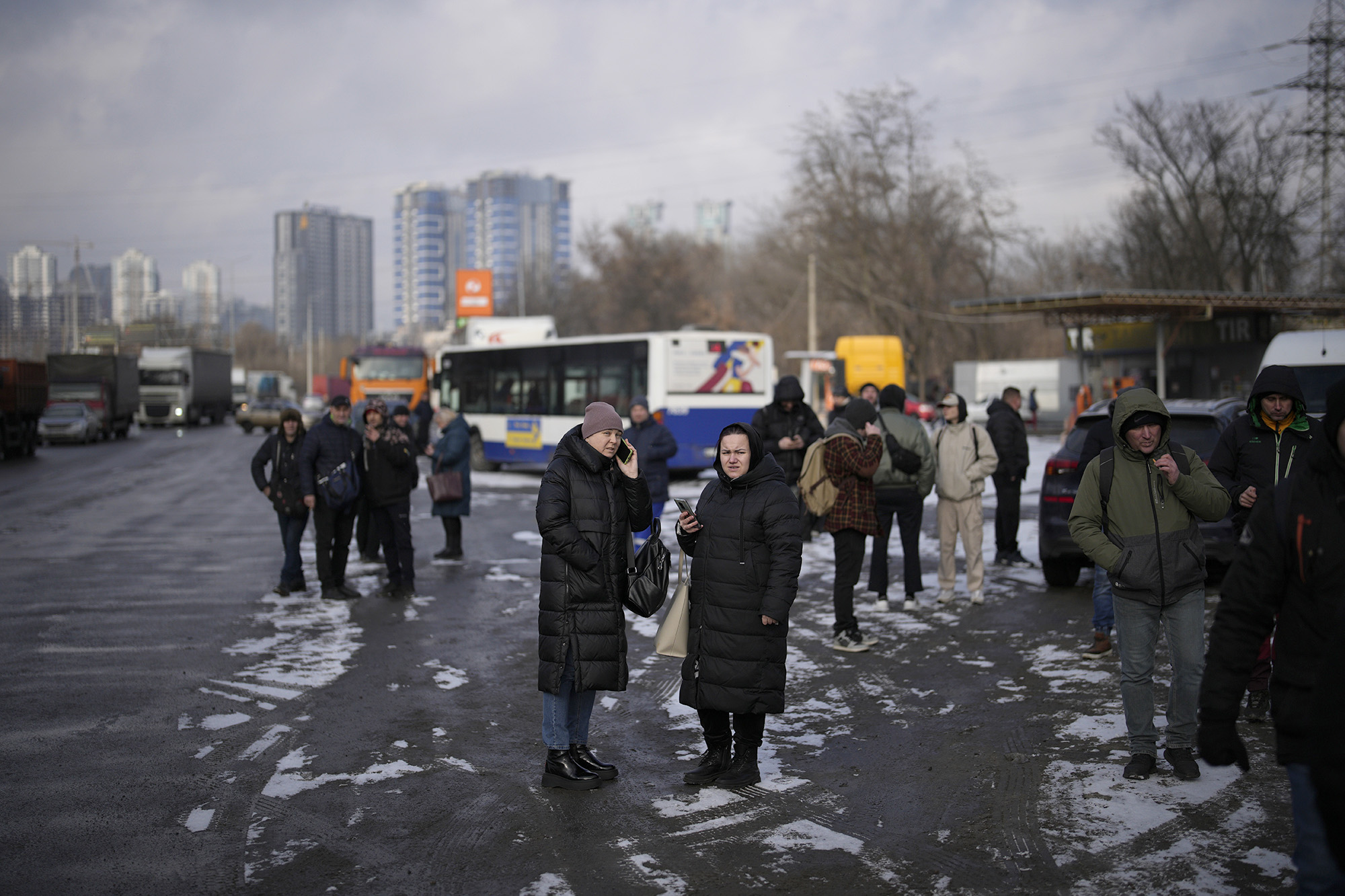 People wait on a street blocked by police after a rocket attack in Kyiv, Ukraine, on January 26.