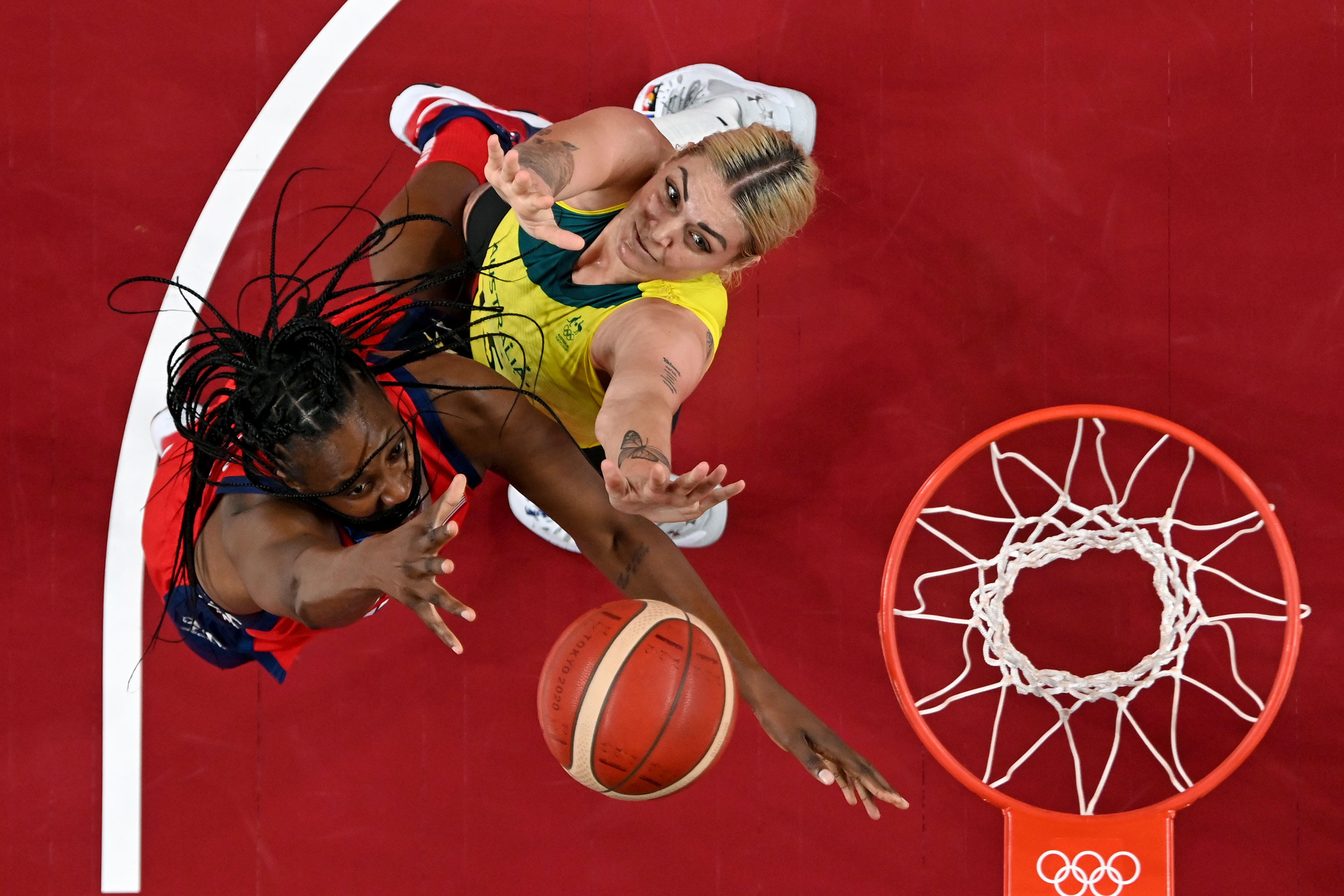 American Sylvia Fowles vies for the ball with Australian Cayla George in their quarterfinal game on August 4.