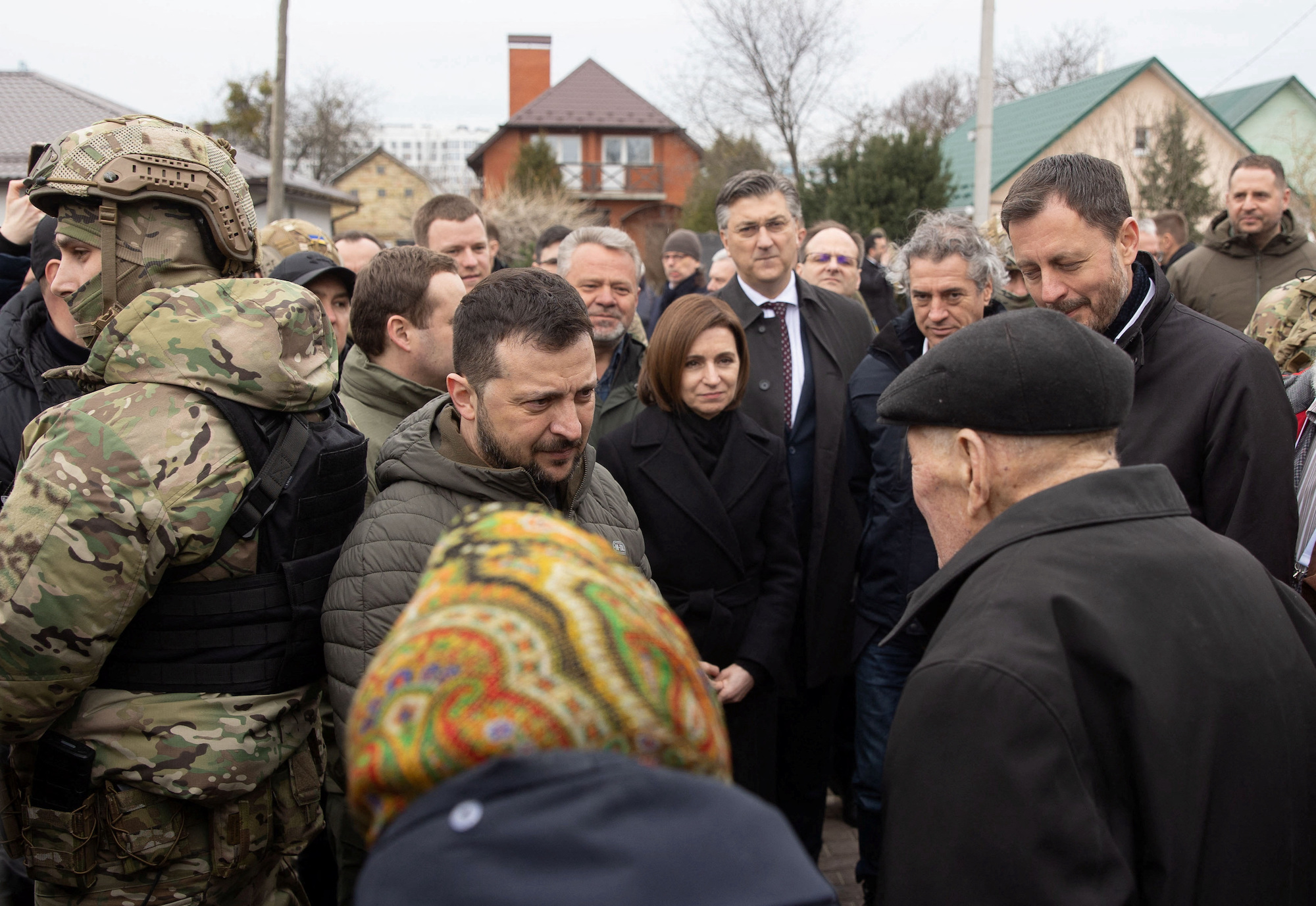 President Volodymyr Zelensky speaks with local residents in the town of Bucha on Friday.