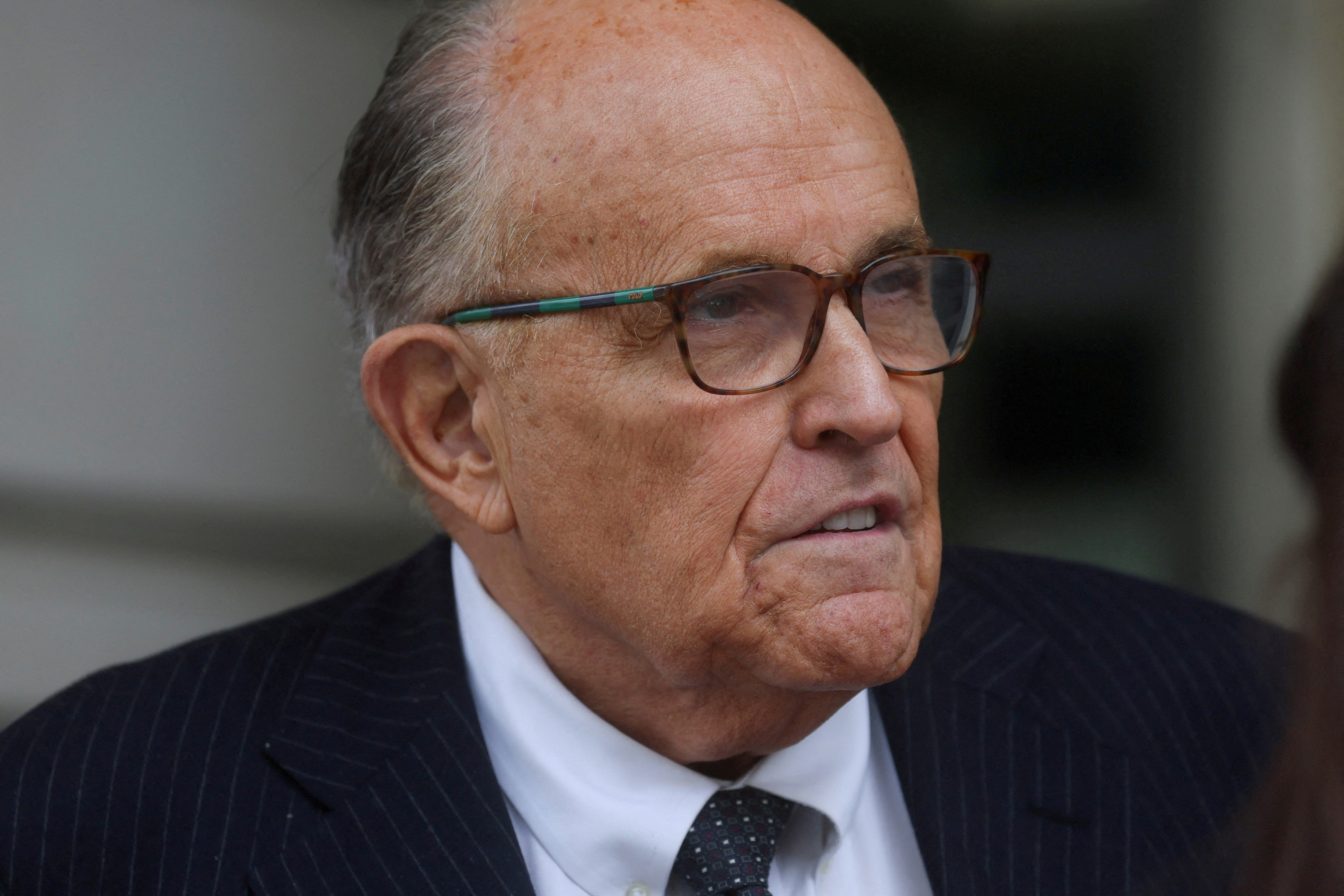 Former New York City Mayor Rudy Giuliani, an attorney for former US President Donald Trump during challenges to the 2020 election results, exits U.S. District Court after attending a hearing in a defamation suit related to the 2020 election results that has been brought against Giuliani by two Georgia election workers, at the federal courthouse in Washington, DC, on May 19.