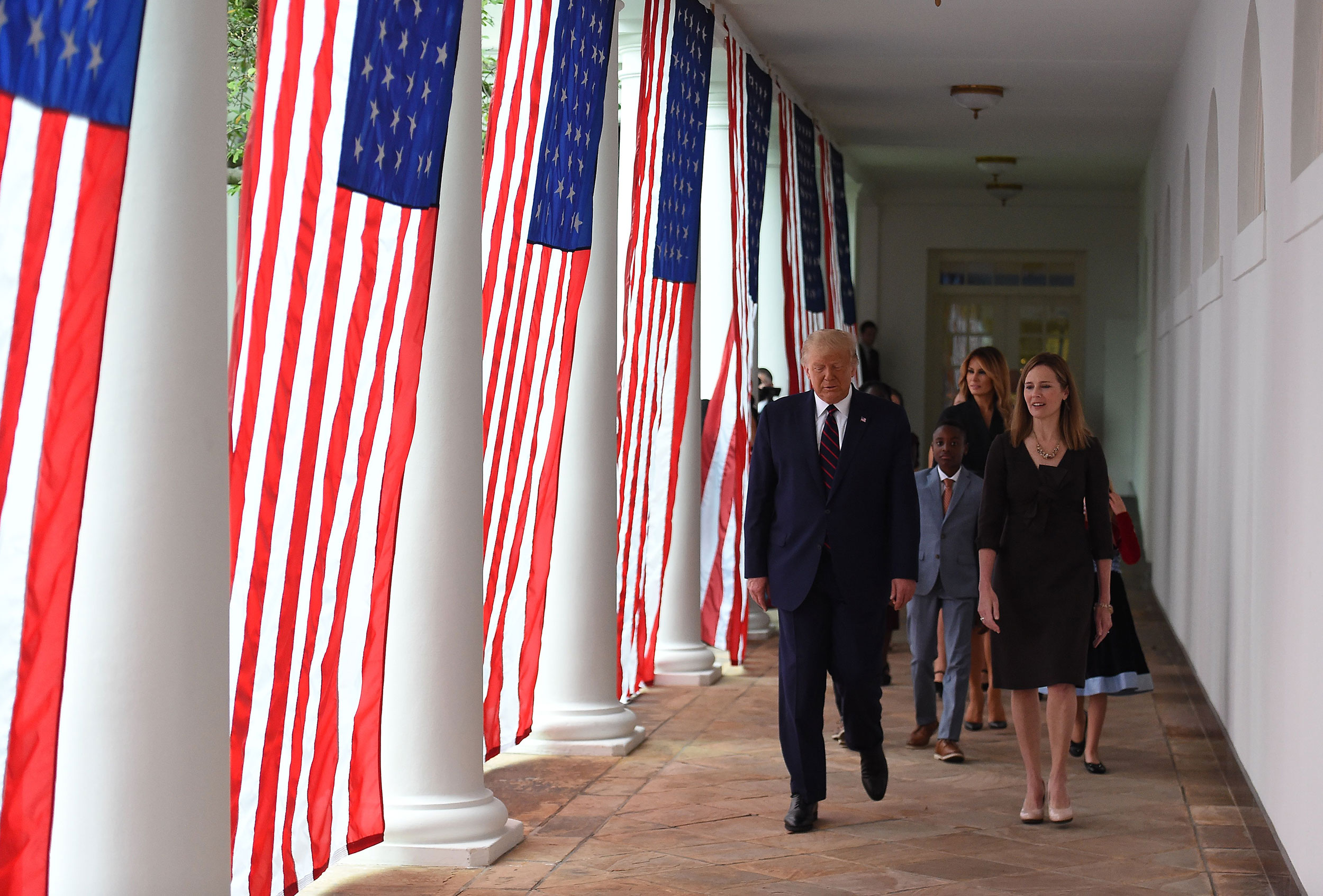 President Donald Trump and Amy Coney Barrett walk to the Rose Garden on Saturday.