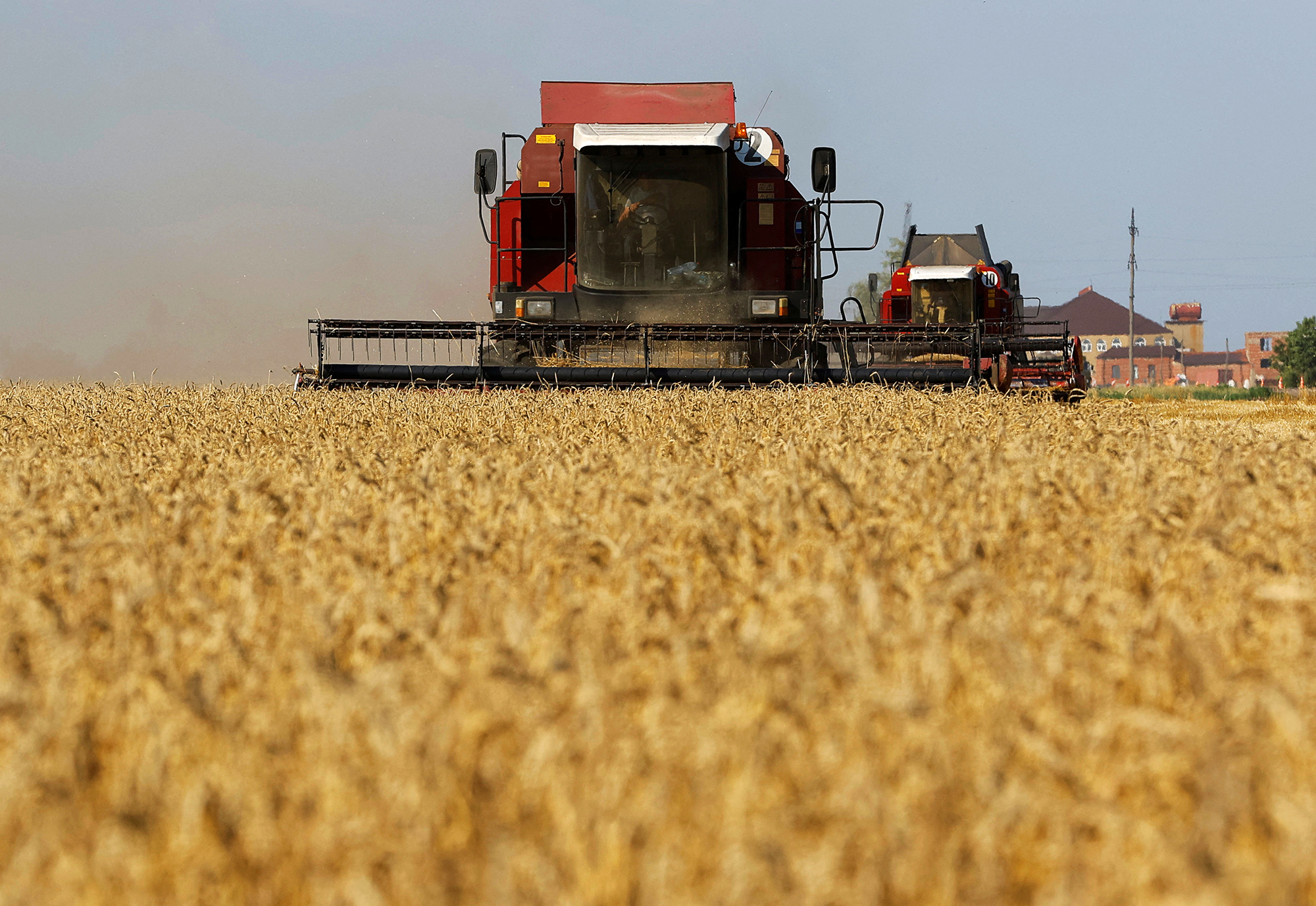 Workers harvest a field of wheat in Zaporizhzhia, Ukraine, on July 4. 