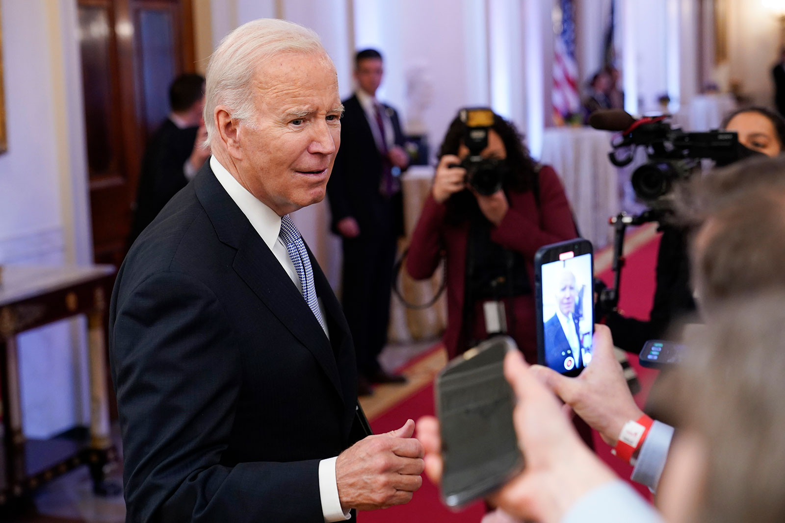 President Joe Biden talks with reporters after speaking in the East Room of the White House on Friday. 