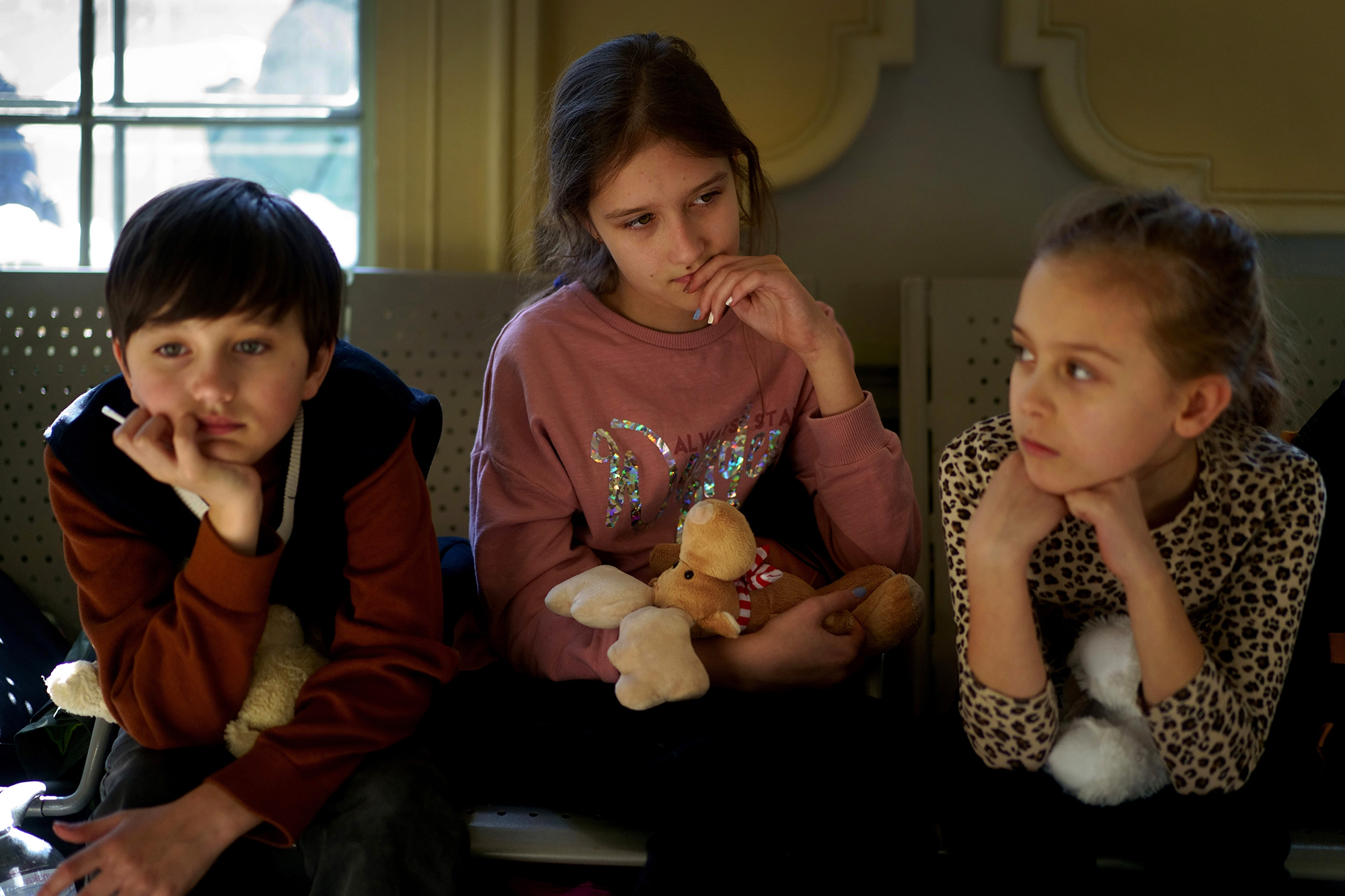 Ukrainian children hold toys while they wait at the Przemysl train station in Poland on March 19. 