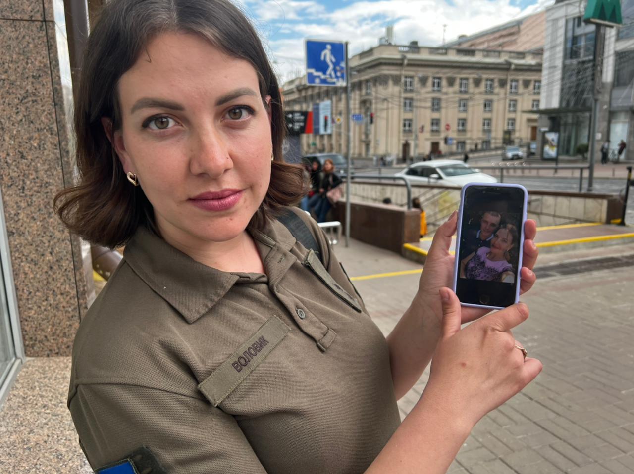Alina Volovik shows a photo of her and her husband, Artem, who are inside the Azovstal tree. 