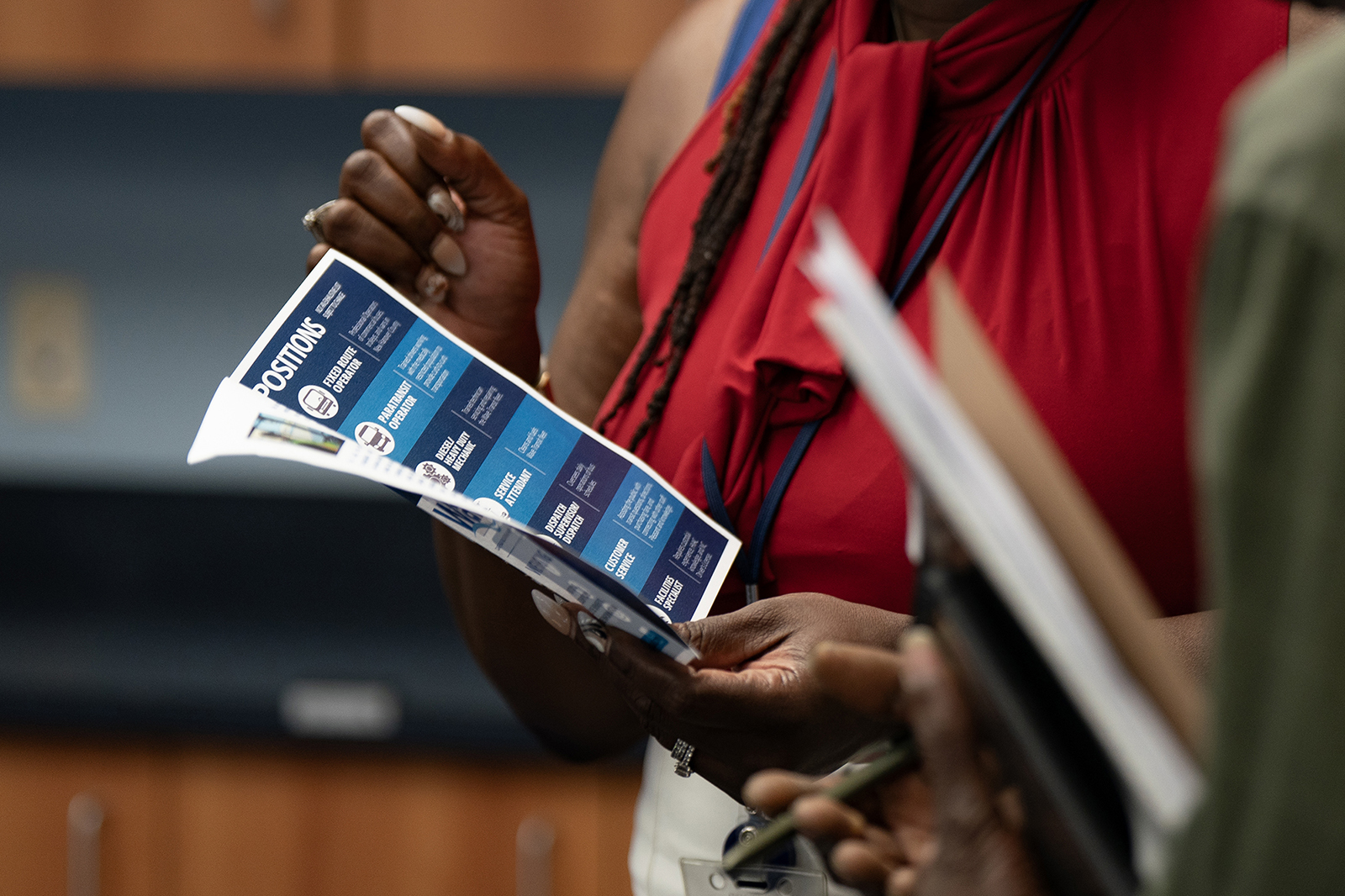 A woman holds a flyer at a career fair hosted by the New Hanover NCWorks and the Cape Fear Workforce Development Board in Wilmington, North Carolina, on June 20.