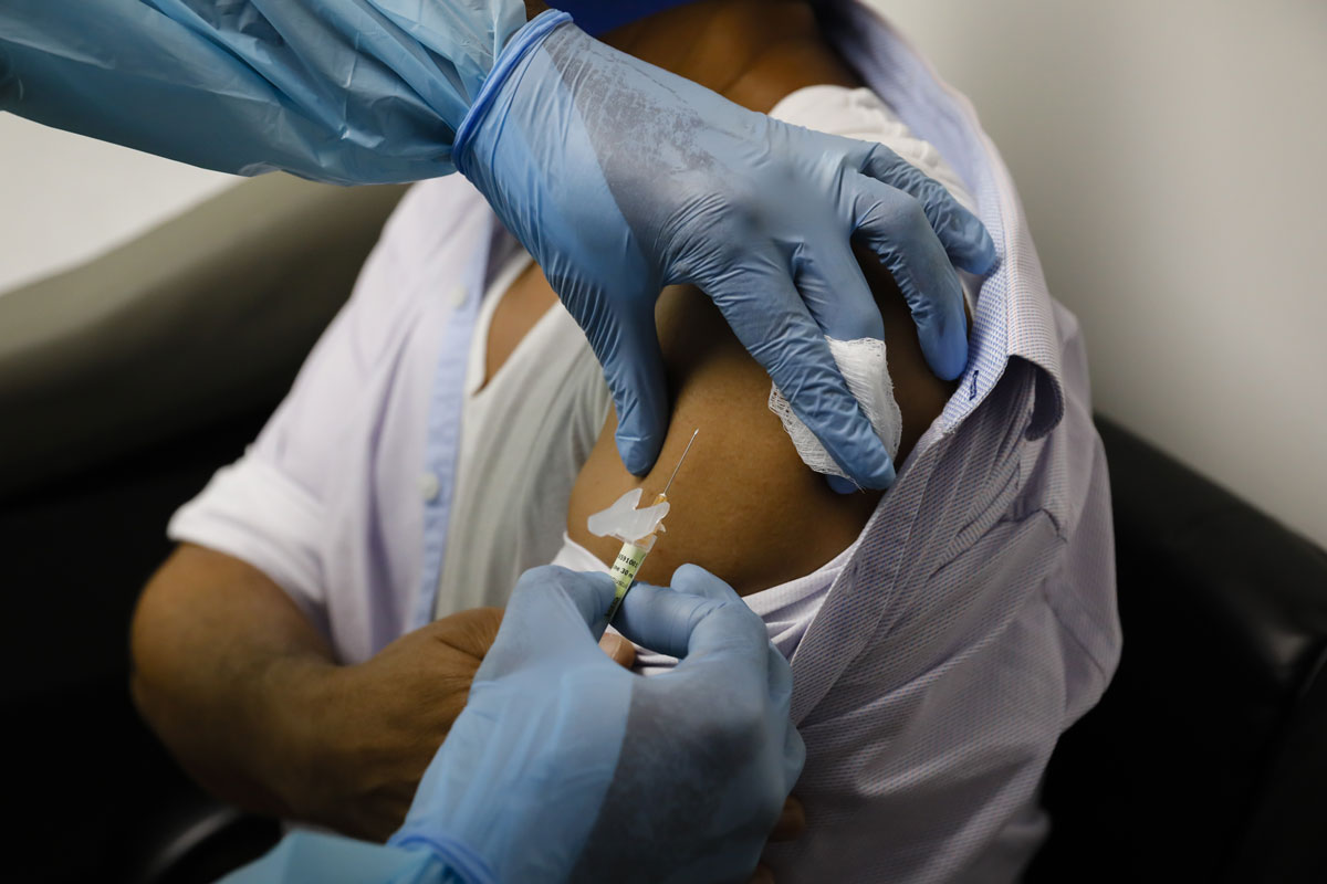 A health worker injects a person during clinical trials for Pfizer's Covid-19 vaccine at Research Centers of America in Hollywood, Florida on September 9.
