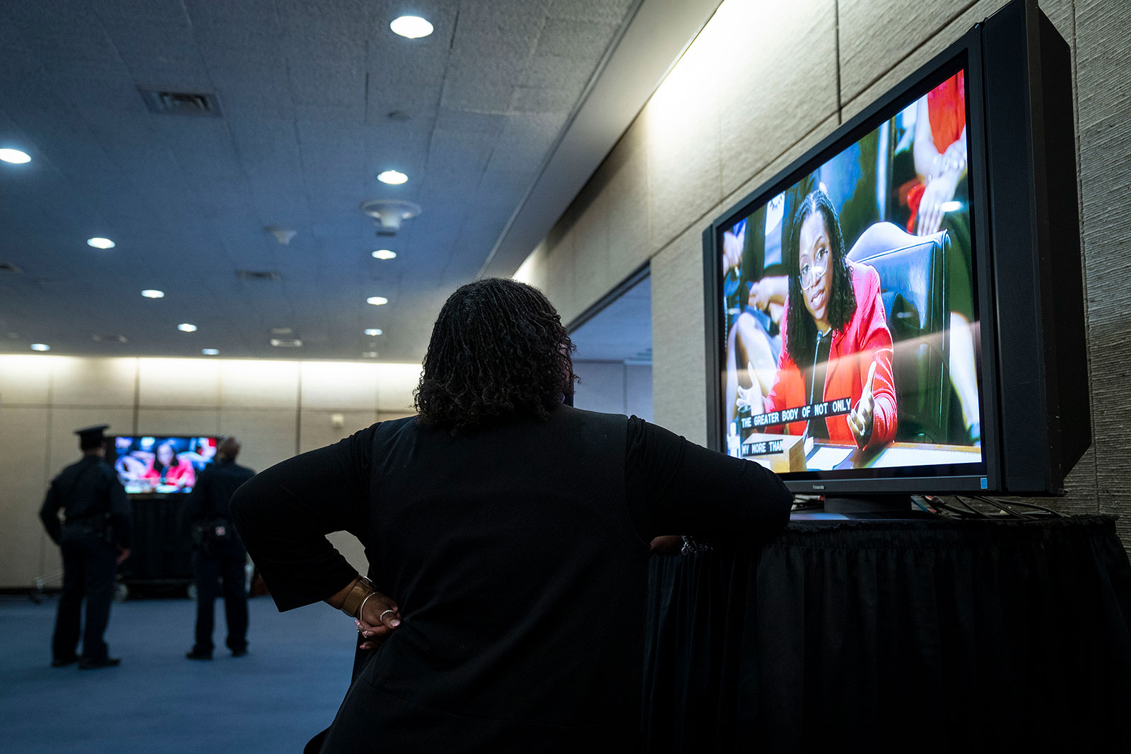 A woman watches a television on Capitol Hill that was streaming Jackson's hearing on Tuesday.