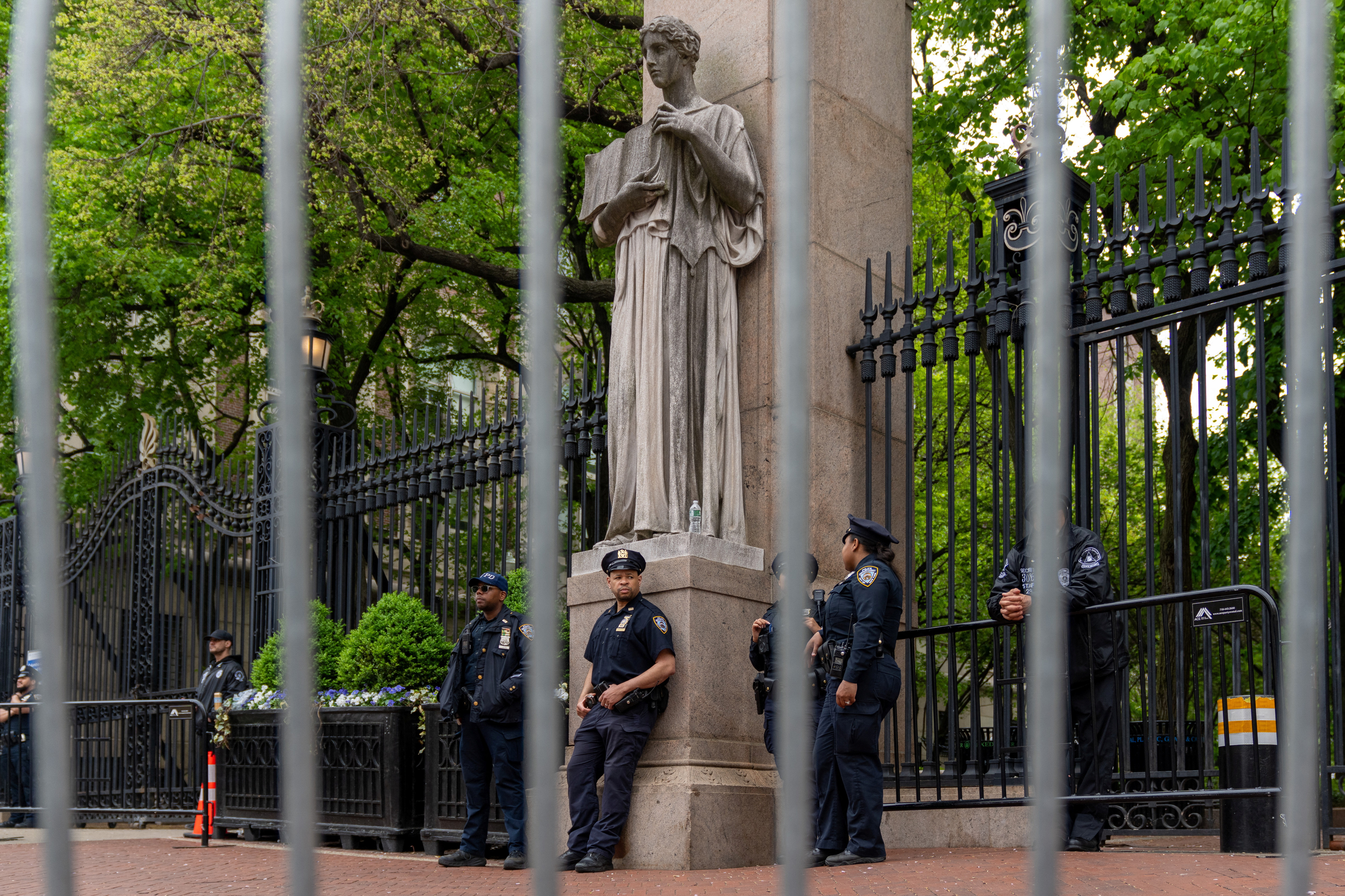 Private security and NYPD police officers stand guard at the gates of Columbia University in New York City, on May 2.