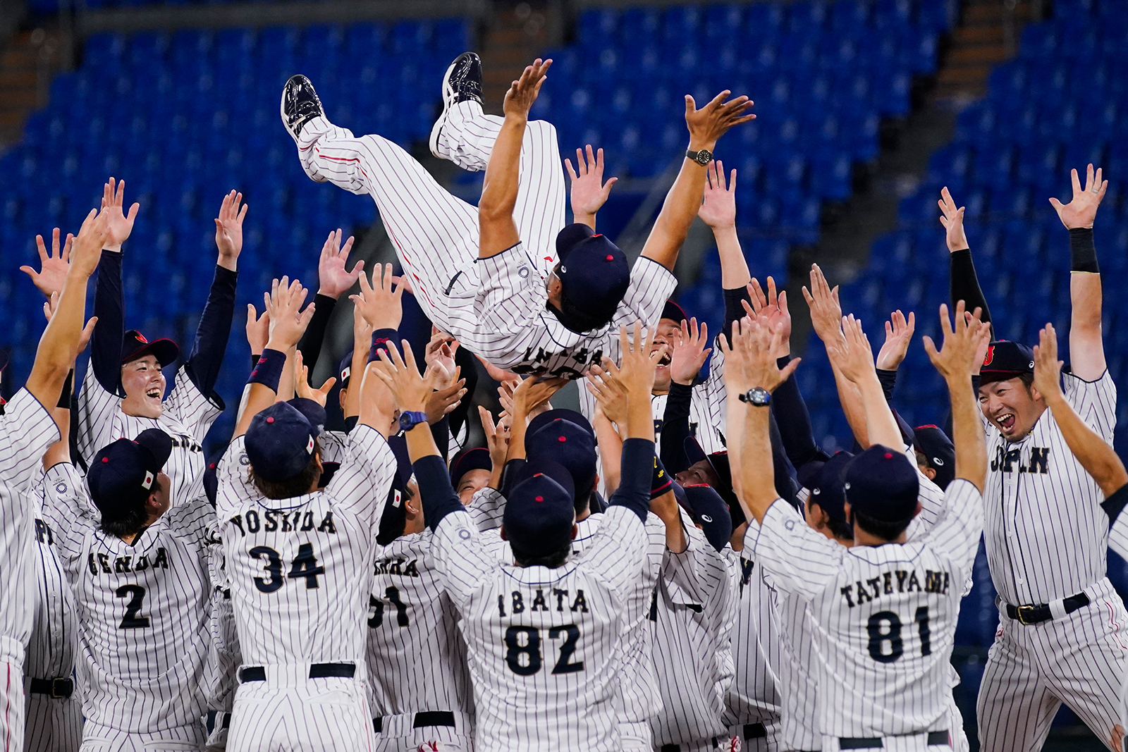 Team Japan celebrate with their manager Atsunori Inaba after the gold medal baseball game against the United States at the 2020 Summer Olympics, on August 7,  in Yokohama, Japan. 