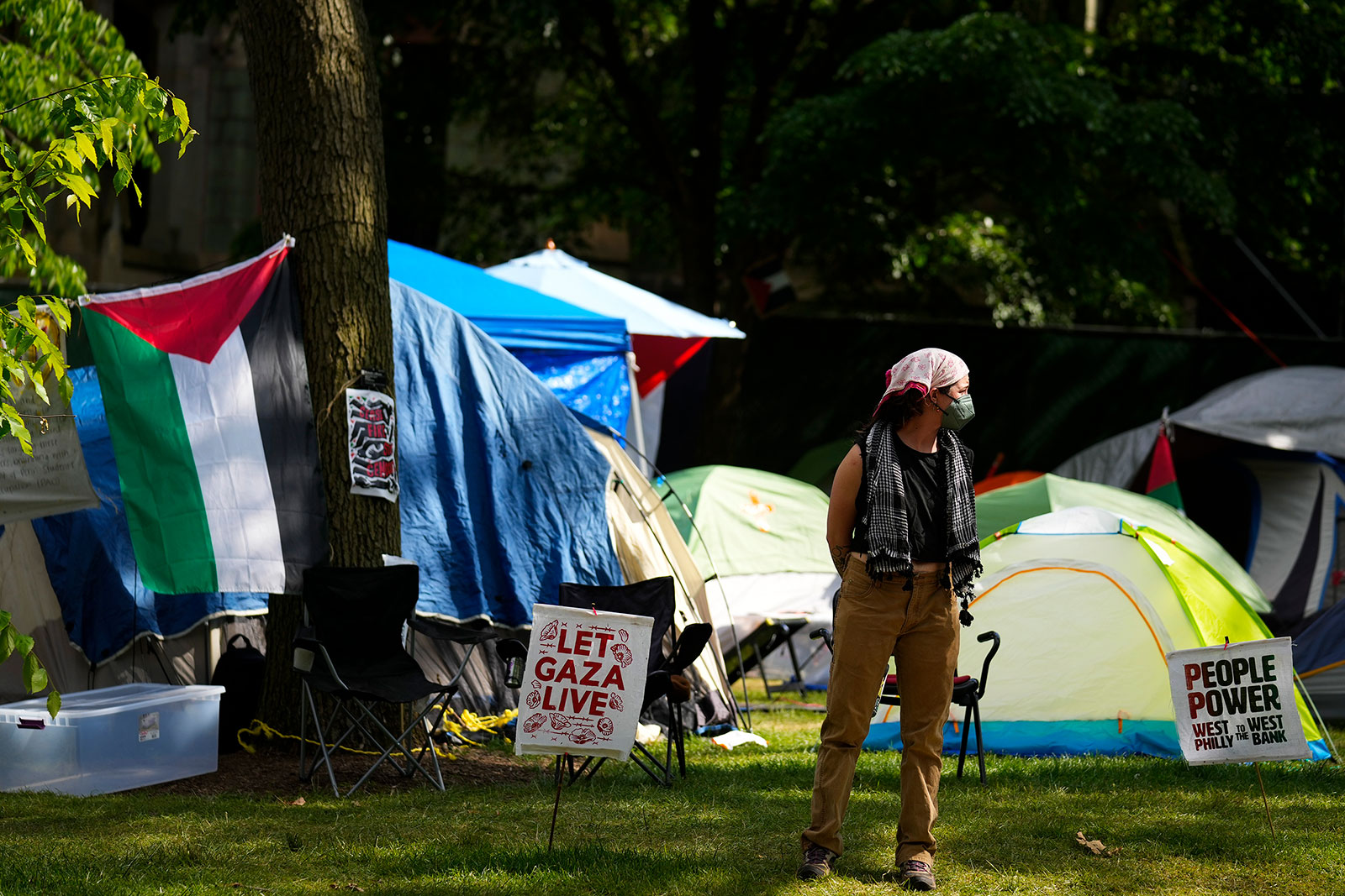 A person stands an encampment at the University of Pennsylvania in Philadelphia, Wednesday, May 1