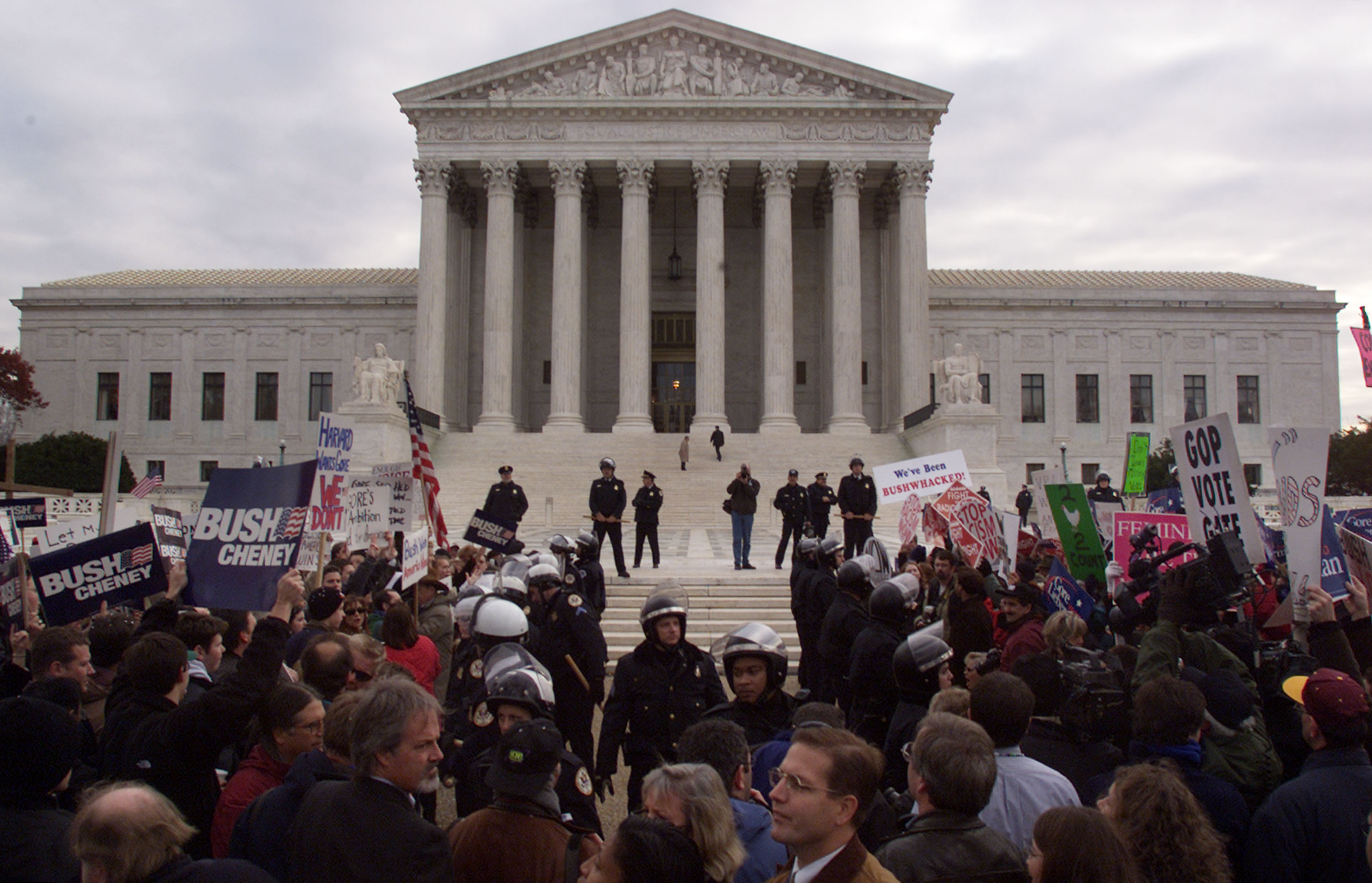 Police officers separate supporters of George W. Bush and Al Gore during demonstrations in front of the US Supreme Court in Washington, DC on Dec. 1, 2000. The court was hearing arguments from lawyers for Bush and Gore in the dispute over Florida''s presidential election ballots.