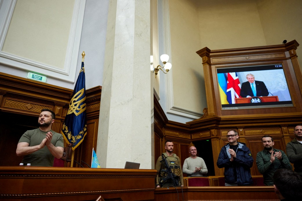 Ukraine's President Volodymyr Zelensky claps during a session of a parliament while British Prime Minister Boris Johnson addresses Ukrainian lawmakers in Kyiv, Ukraine, via videolink, on May 3.