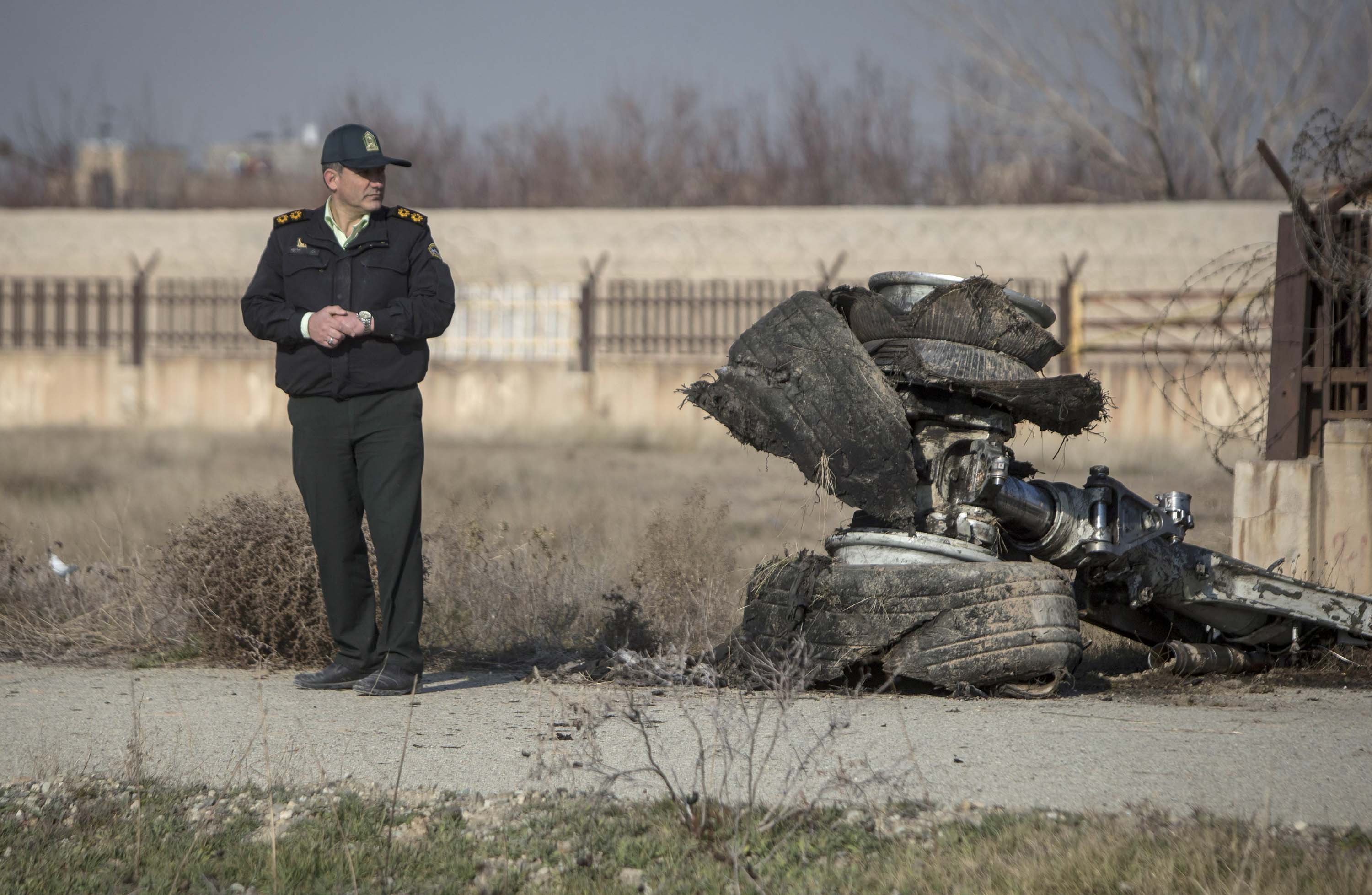 An official stands near wreckage from the plane on Wednesday.