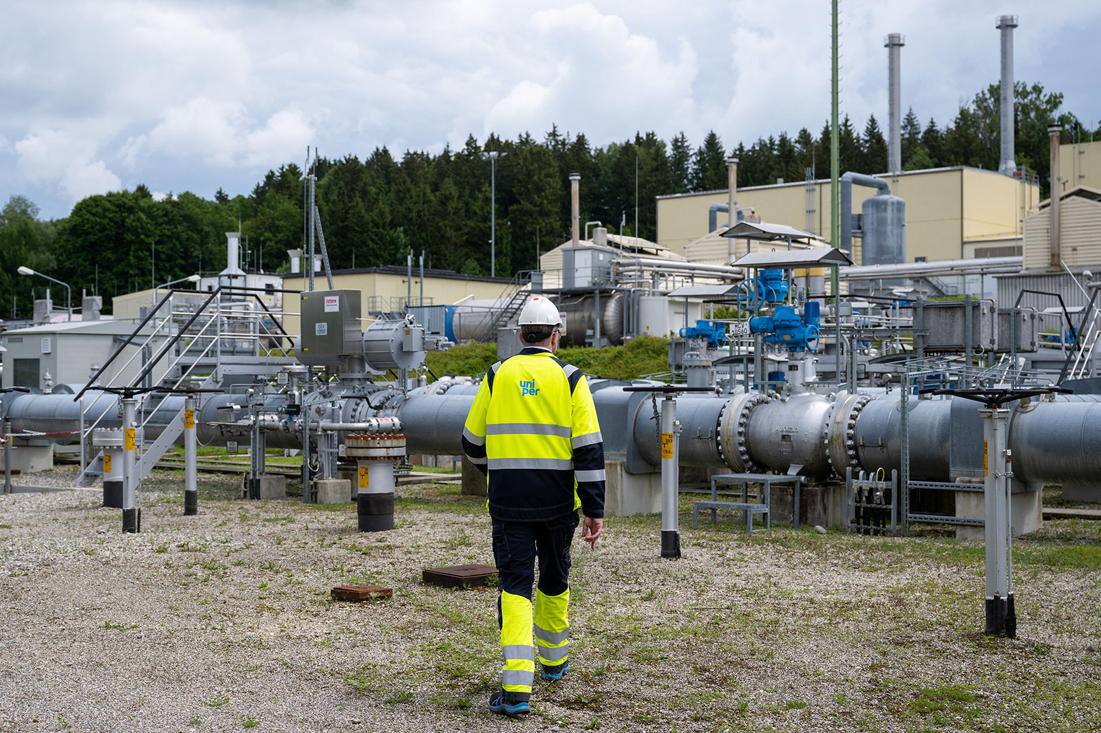 An worker walks through the above-ground facilities of a natural gas storage facility at the Uniper Energy Storage facility in Bierwang, Germany, on June 10.