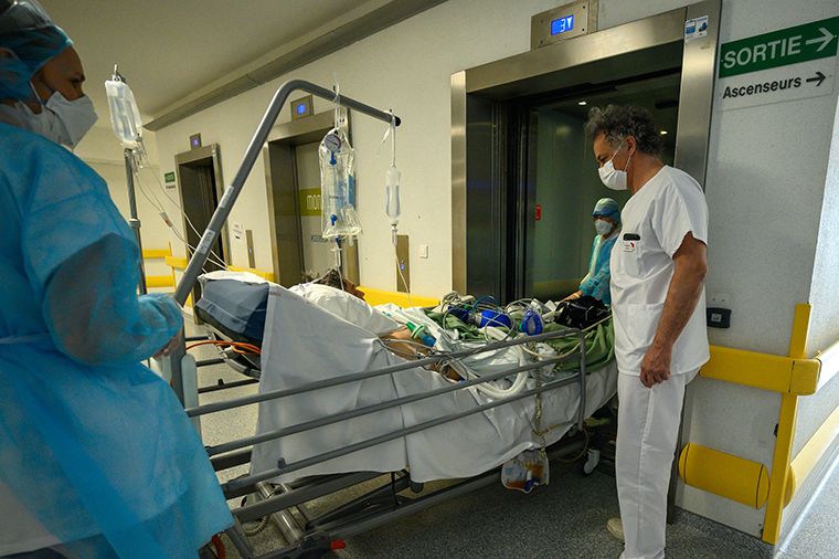 A patient infected with COVID-19 is transferred to intensive care from on April 17, at the Emile Muller hospital in Mulhouse,  France.