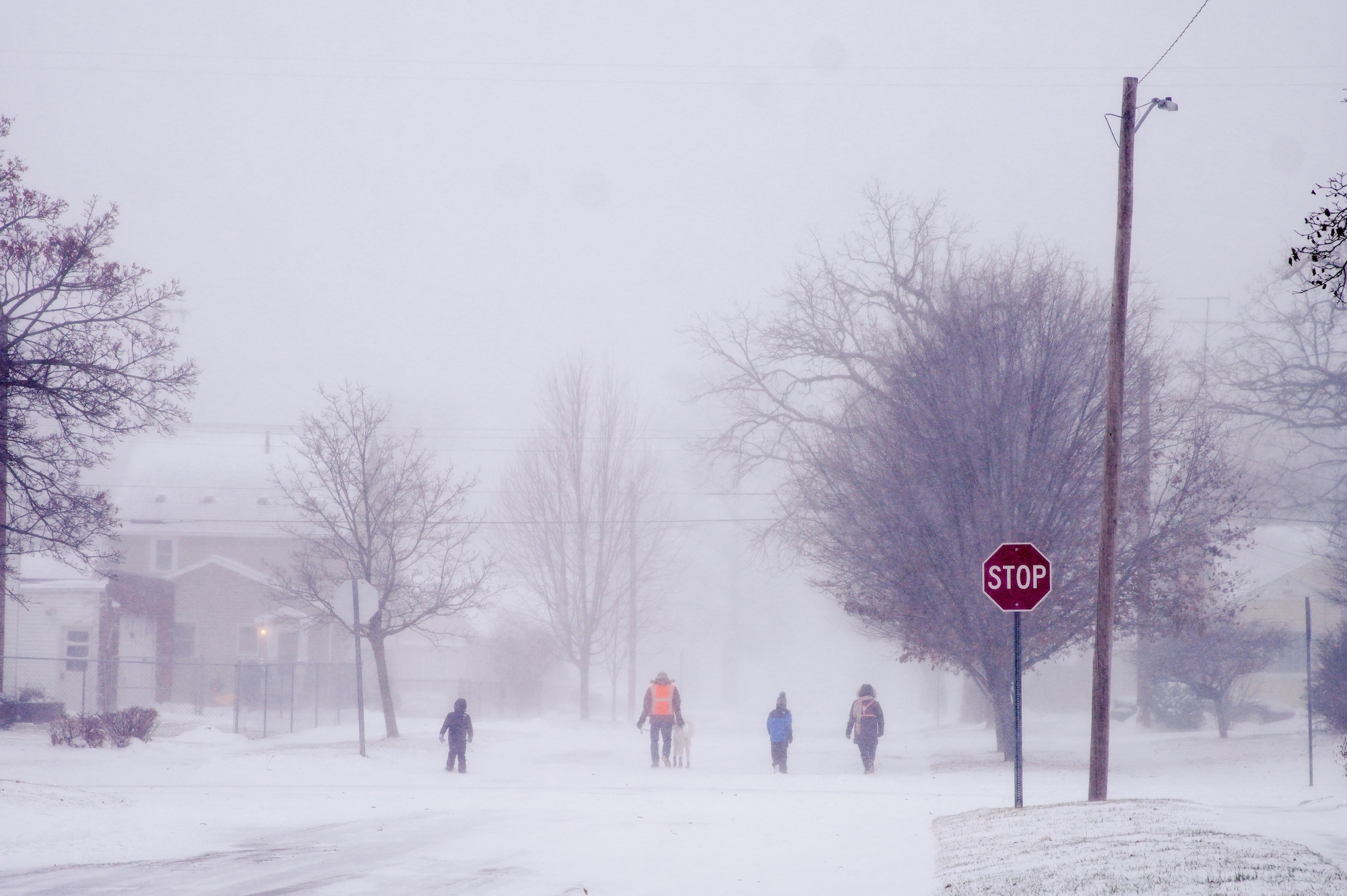 A group of people walk through a neighborhood in Flint, Michigan, on Saturday.