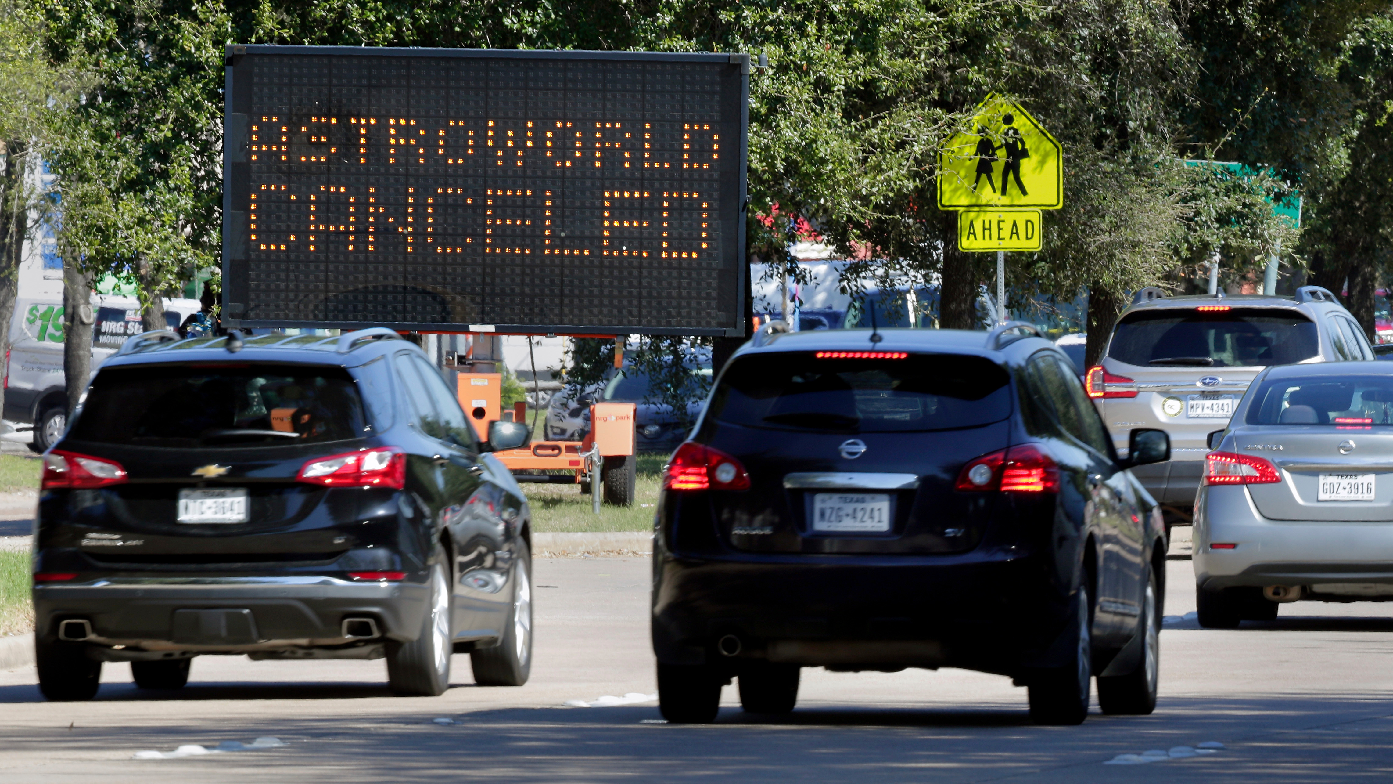 Traffic passes by a sign announcing the cancellation of Astroworld on Saturday, November 6, in Houston.