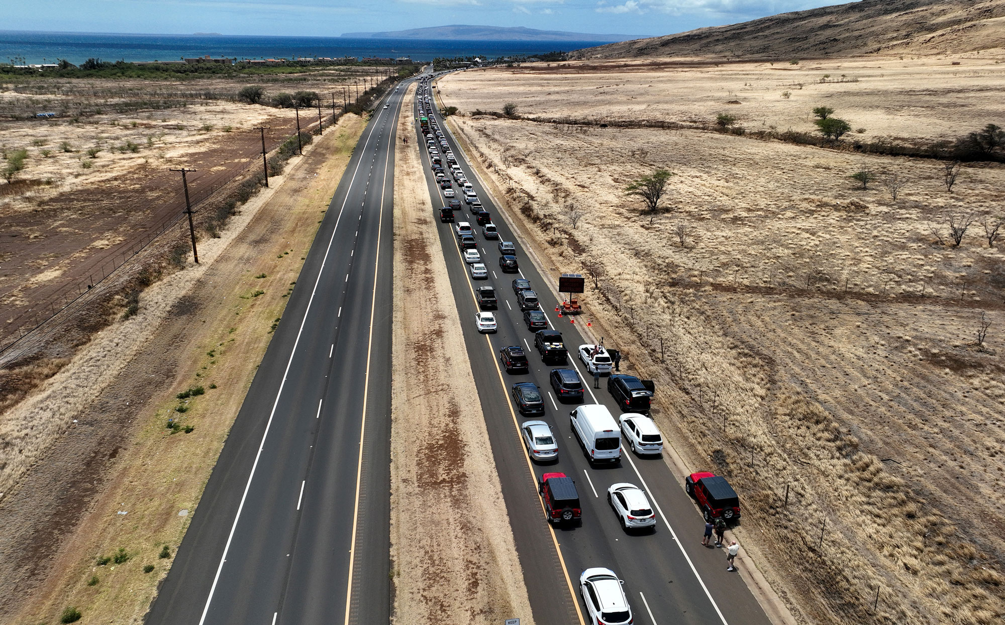 In an aerial view, cars back up for miles on the Honoapiilani highway as residents are allowed back into areas affected by the recent wildfire on August 11, 2023 in Wailuku, Hawaii.