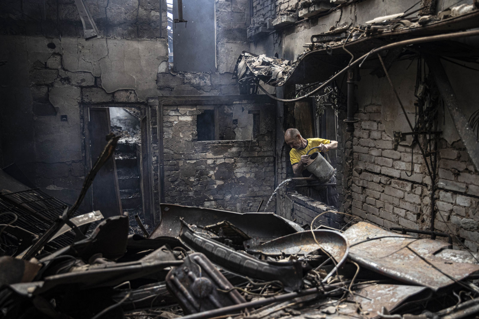 A man tries to extinguish fire in a damaged house after a Russian airstrike in Slavyansk, Donetsk oblast on Tuesday.