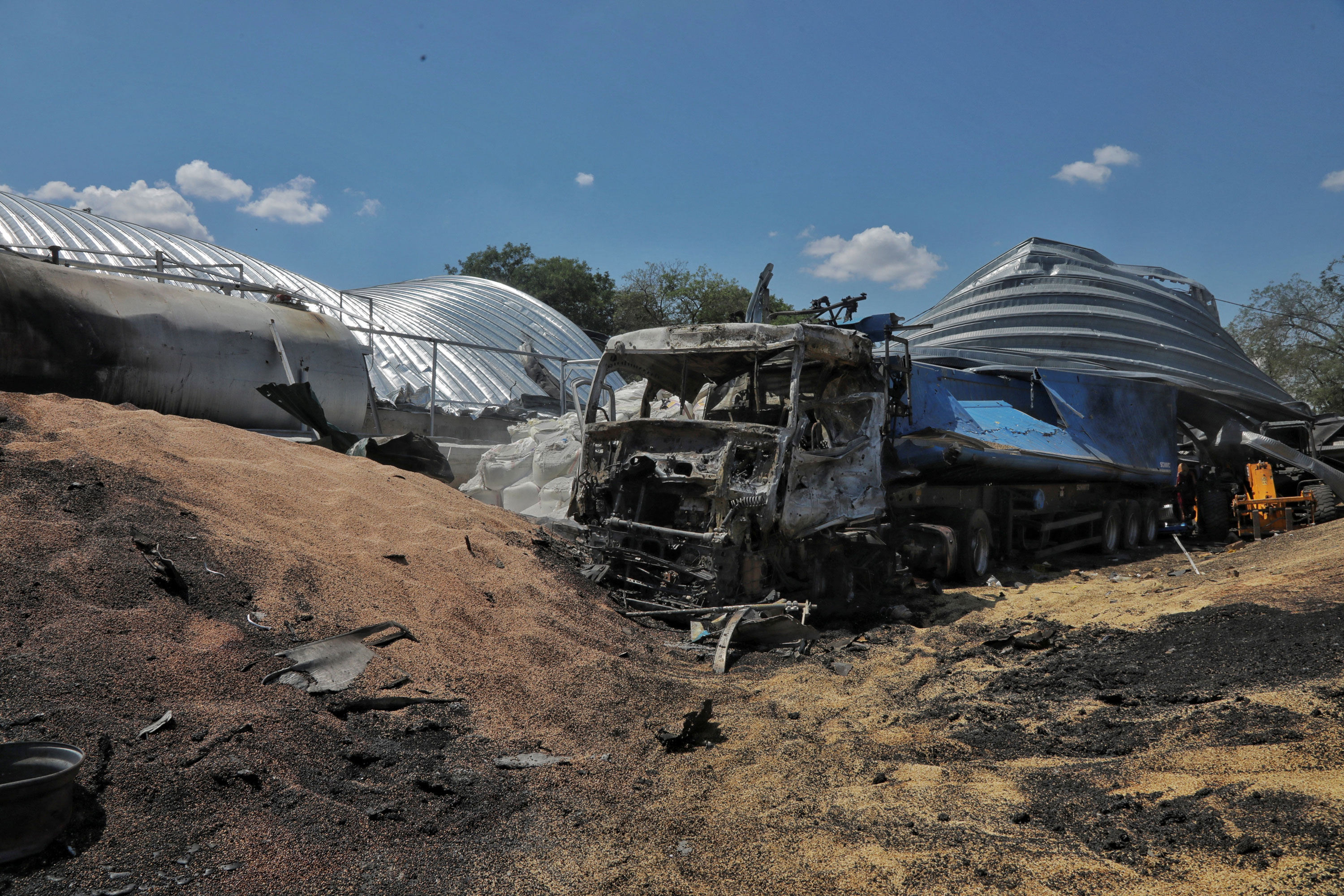 A view shows barley and a damaged truck where a grain warehouse was destroyed by a Russian missile strike at a compound of an agricultural company in the village of Pavlivka, in Odesa region, Ukraine, on July 21, 2023.