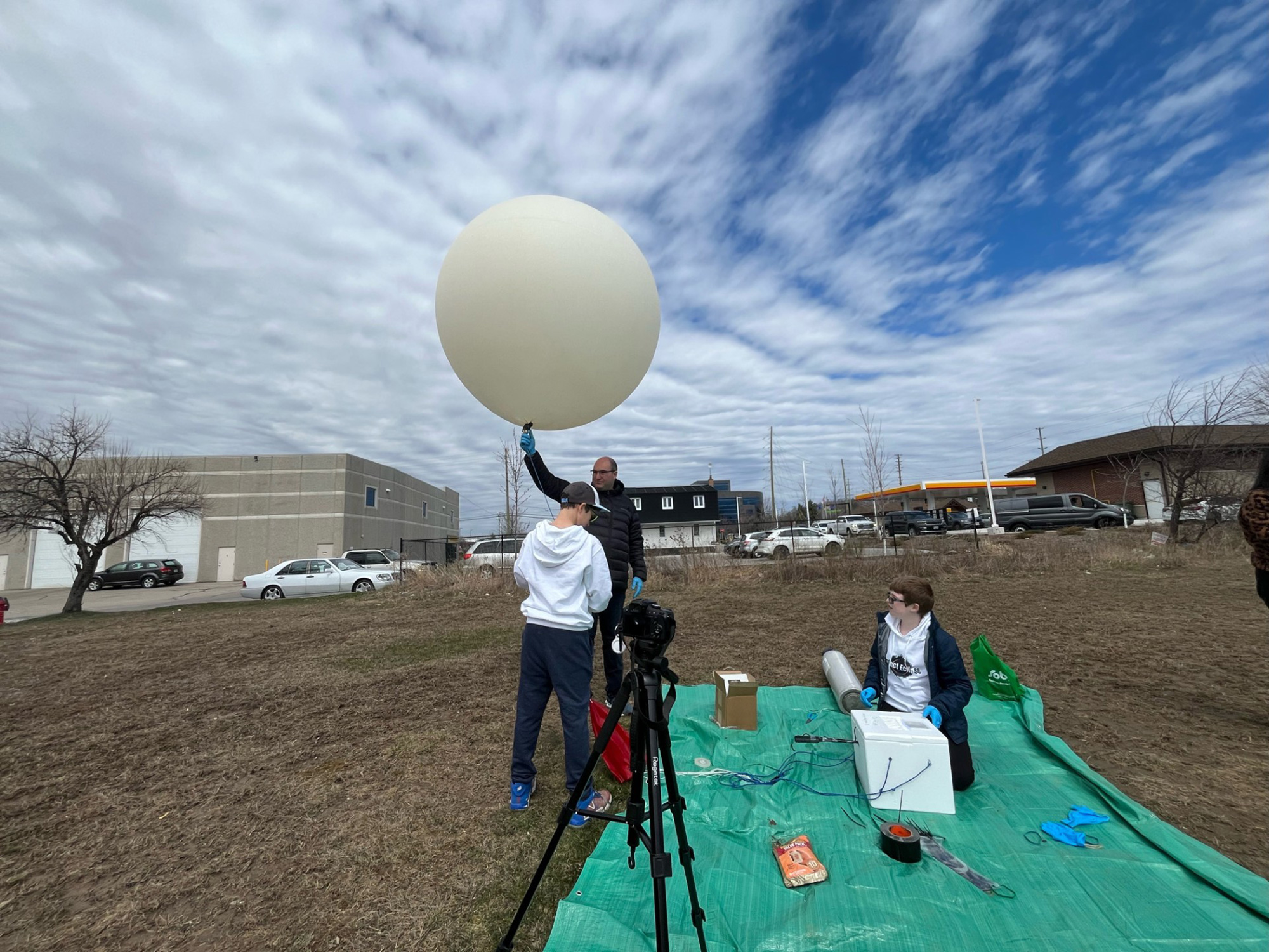 Members of the team prepare the weather balloon for release.
