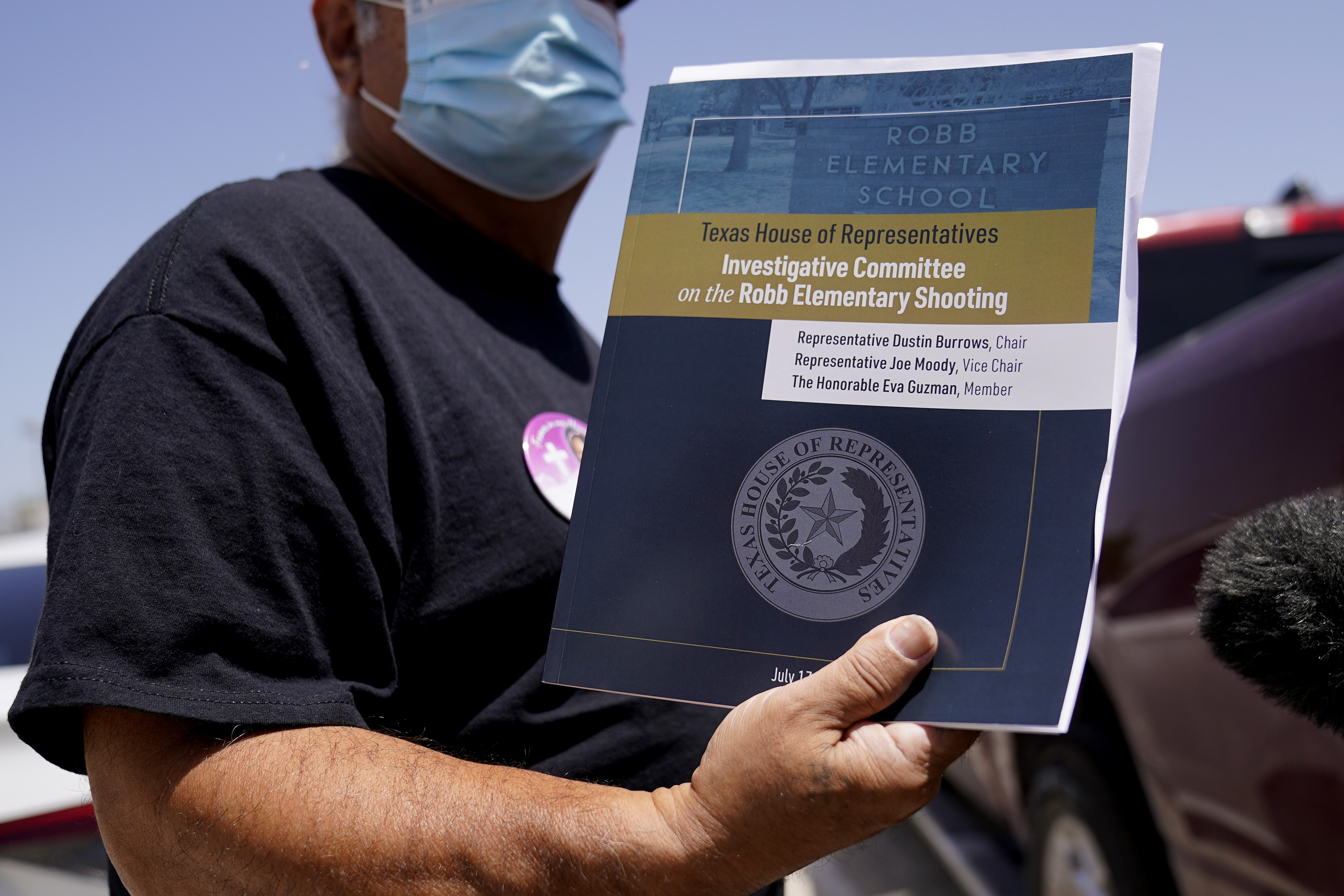 Vincent Salazar, grandfather of Layla Salazar who was killed in the school shooting at Robb Elementary, holds a report released by the Texas House investigative committee on the shootings at Robb Elementary School on Sunday, July 17, in Uvalde, Texas.