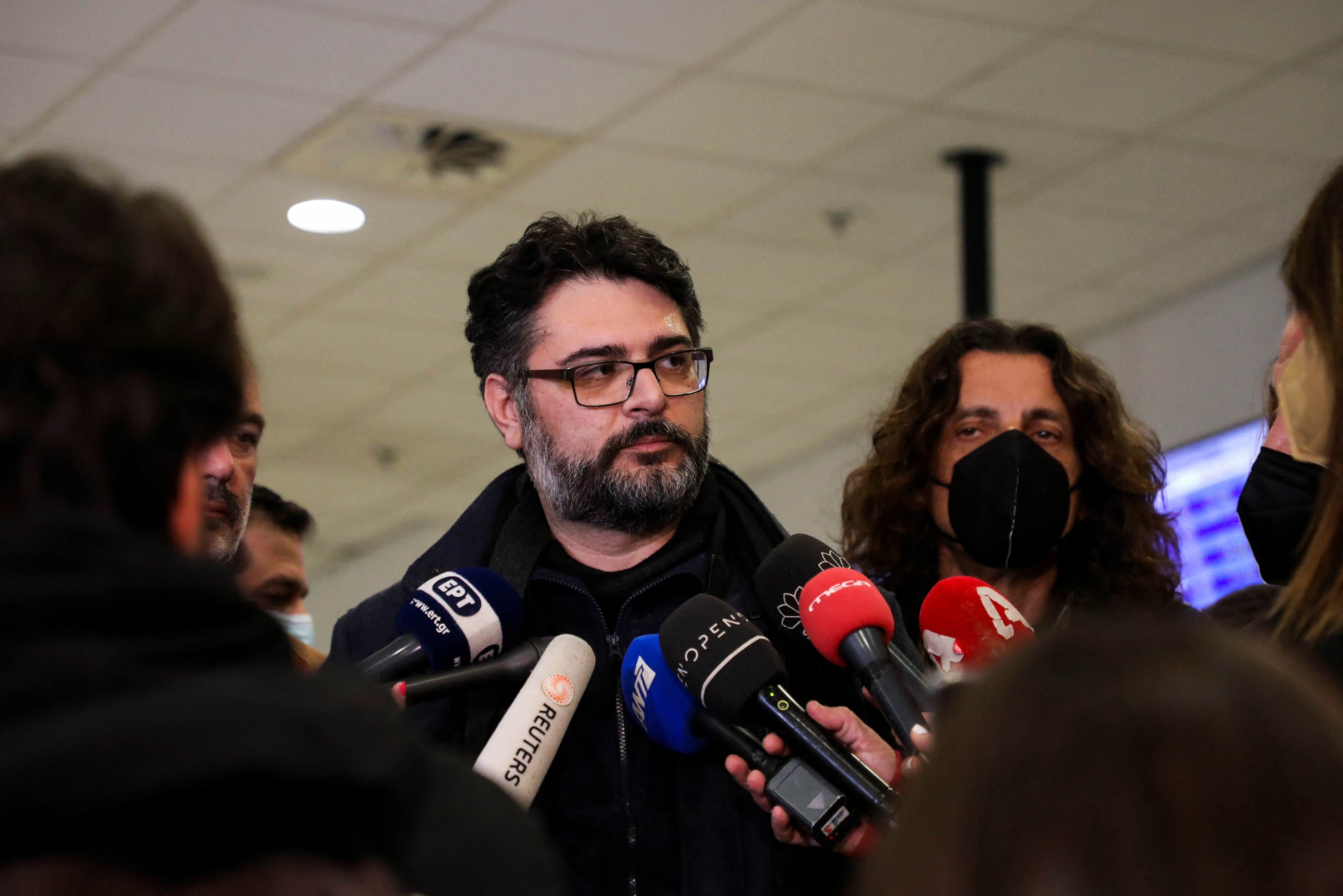 Greece's Consul General Manolis Androulakis talks to the media after arriving back in Greece by plane from Romania after evacuating the city of Mariupol, Ukraine on March 15 and arriving in Athens, Greece, on March 20.