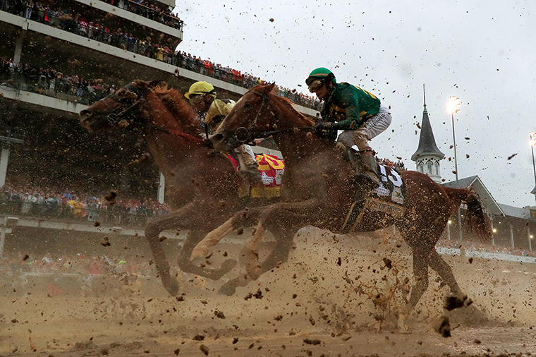 Country House and Code of Honor head to the first turn during 145th running of the Kentucky Derby at Churchill Downs on May 04, 2019 in Louisville, Kentucky. 