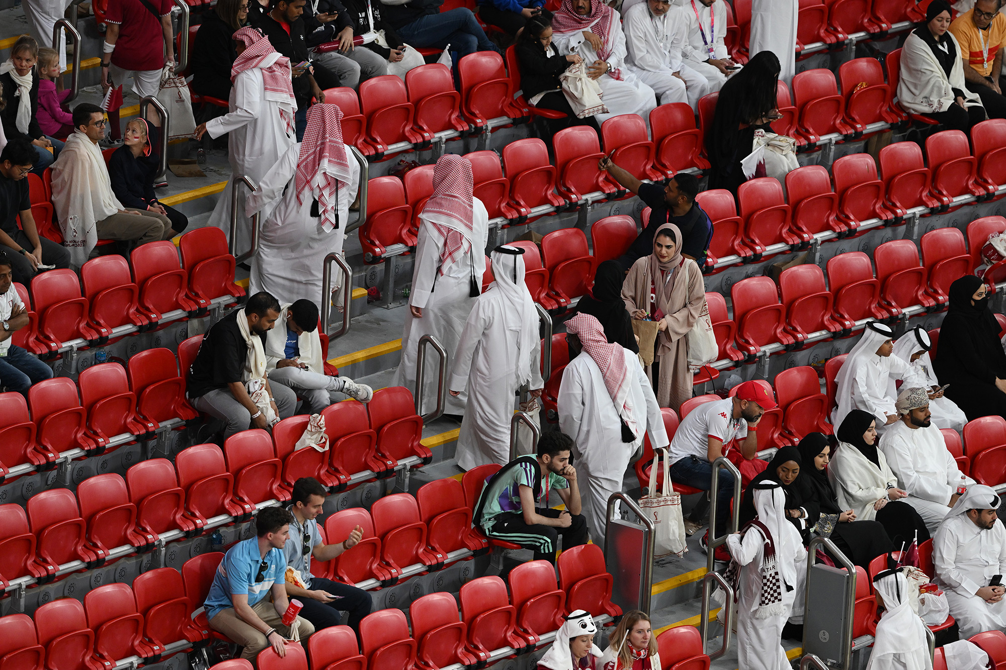Spectators leave Al Bayt Stadium before the end of the Qatar-Ecuador match.