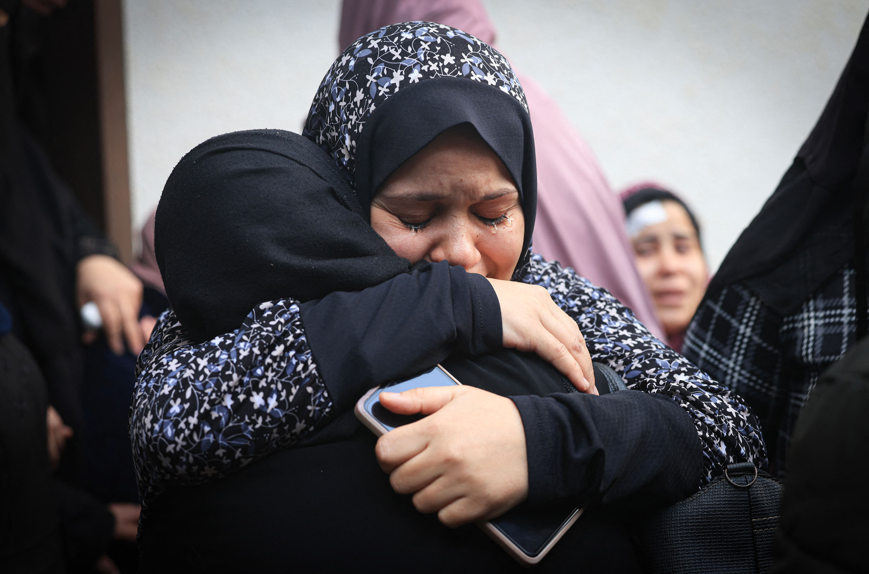 Palestinians from the Ashour family mourn the death of loved ones who were killed in Israeli bombardment in Rafah, Gaza, on December 14.