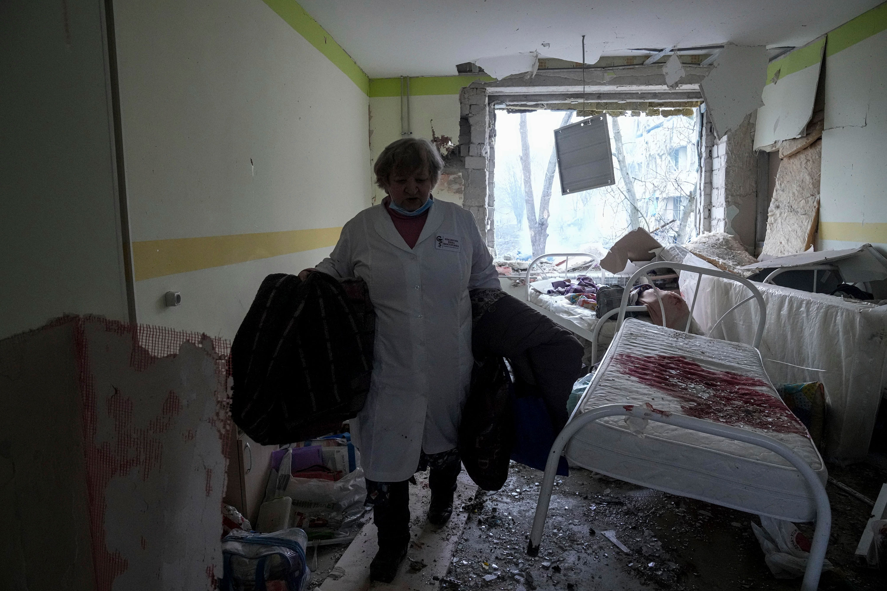 A medical worker walks inside of the damaged hospital in Mariupol.