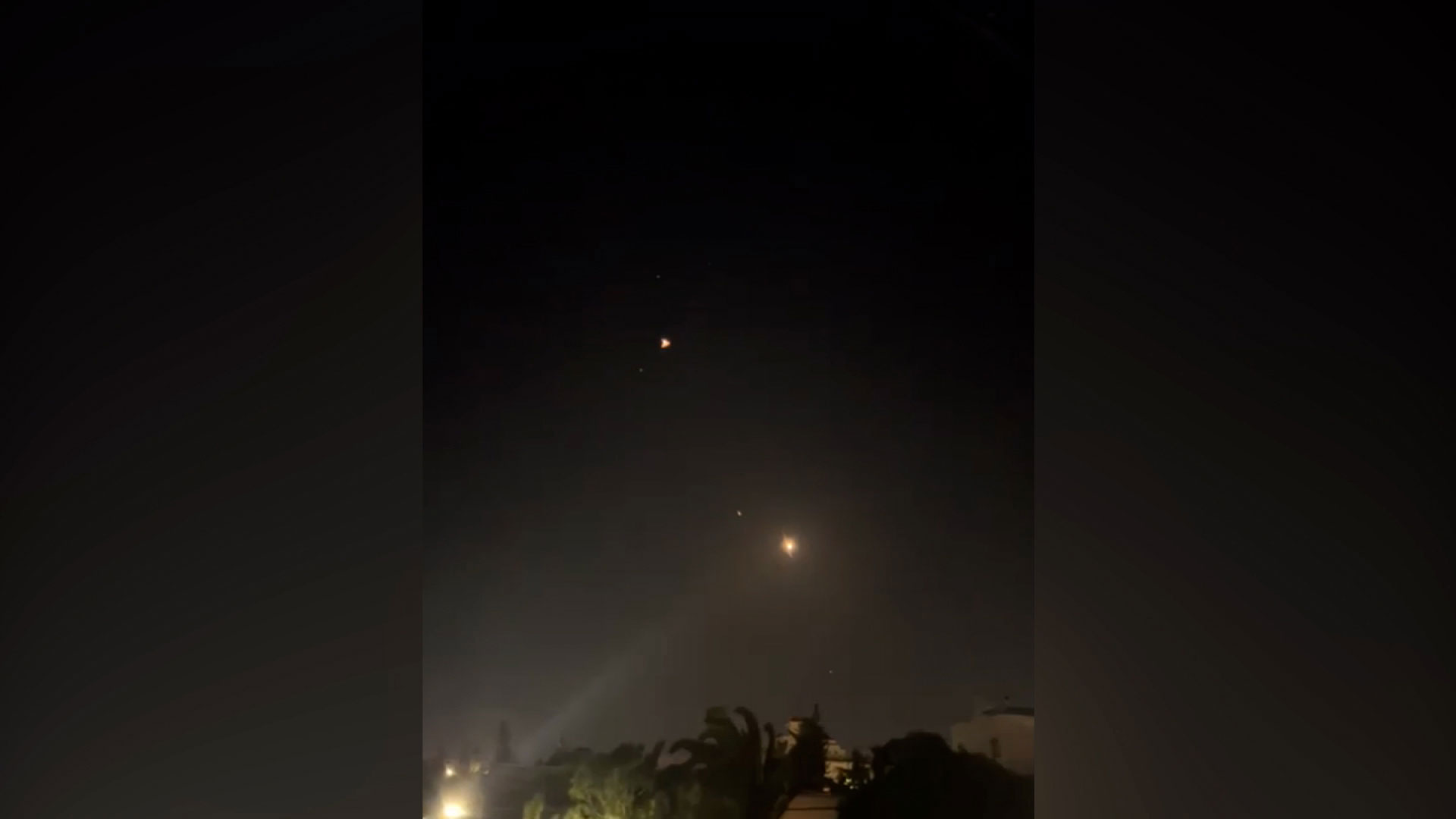 Flashes are seen in the sky over Amman, Jordan, early Sunday, local time. 