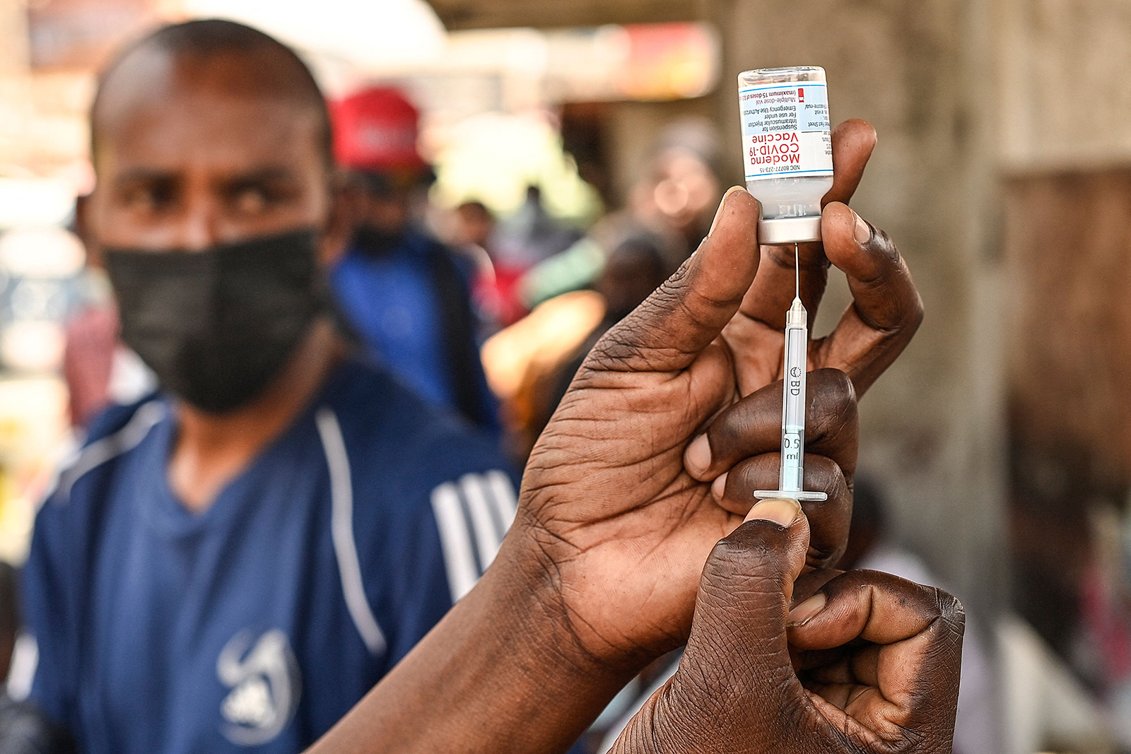 A health official prepares a syringe with the Moderna vaccine prior to administering it during a vaccination drive in Nairobi, Kenya on September 17.