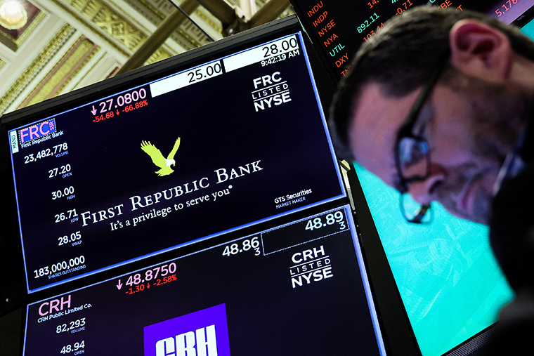 A trader works at the post where First Republic Bank is traded on the floor of the New York Stock Exchange on March 13.
