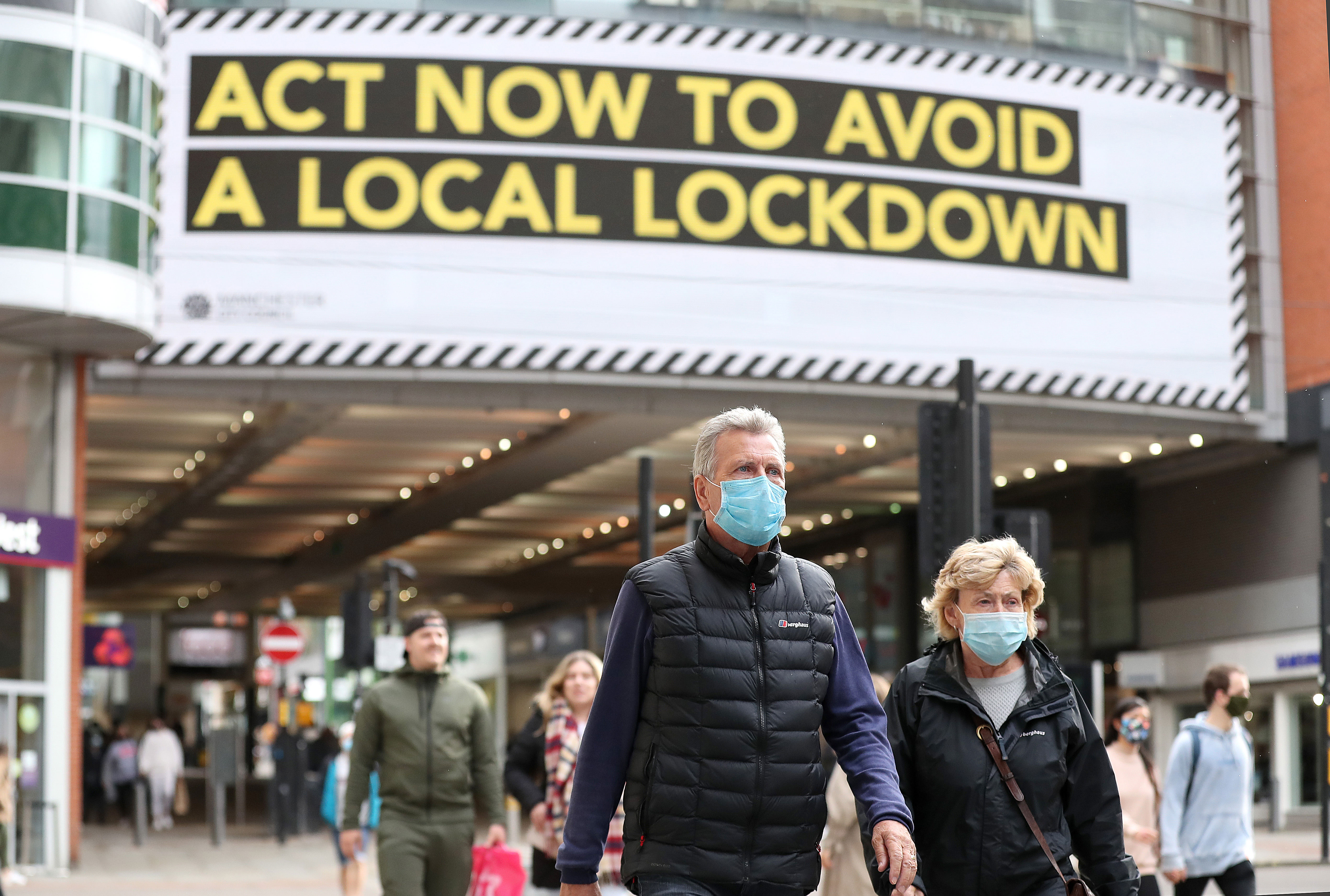 People walk on Market Street in Manchester, England, on October 15.