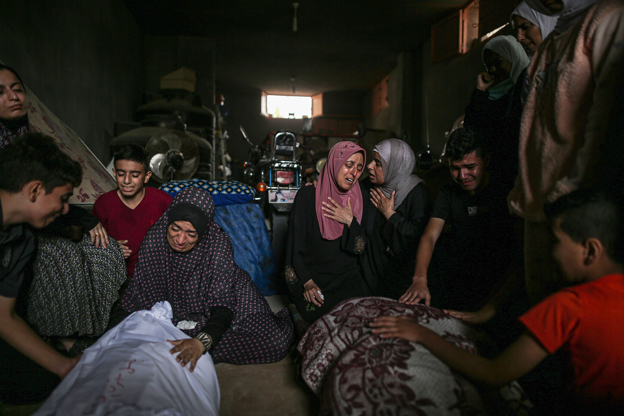 Relatives of people killed in Israeli attacks mourn during funeral prayers in Khan Younis, Gaza, on November 13.