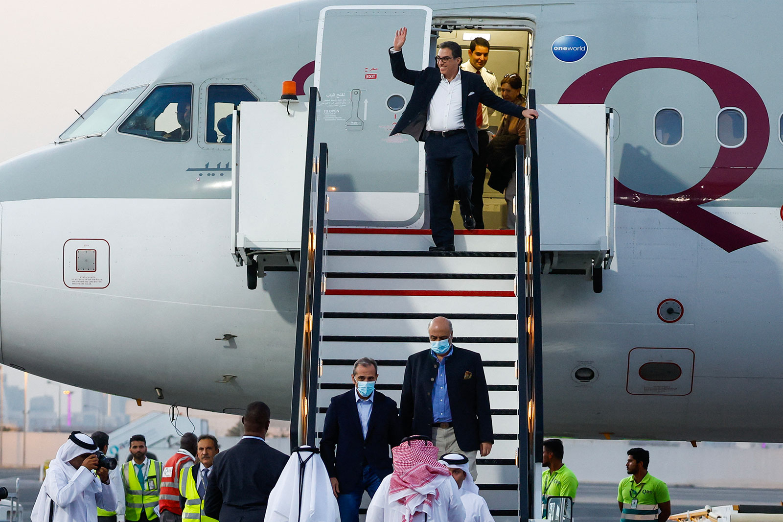Siamak Namazi waves as he disembarks a plane in Doha, Qatar, on Monday.
