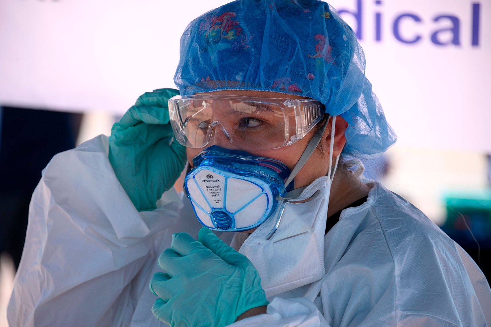 A medical worker adjusts her personal protective equipment at an antibody rapid serological testing site on July 26, in San Dimas, California.