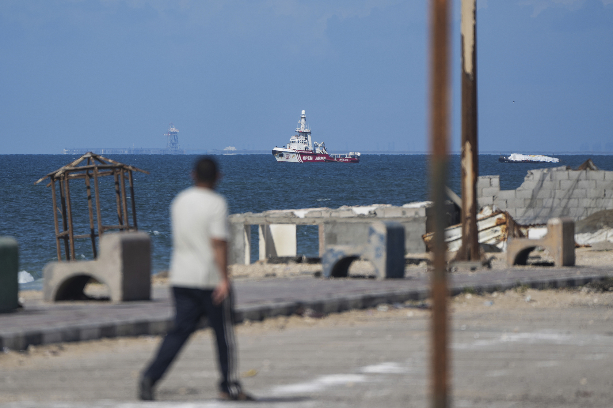 A ship belonging to the Open Arms aid group approaches the shores of Gaza towing a barge with 200 tons of humanitarian aid on March 15. 