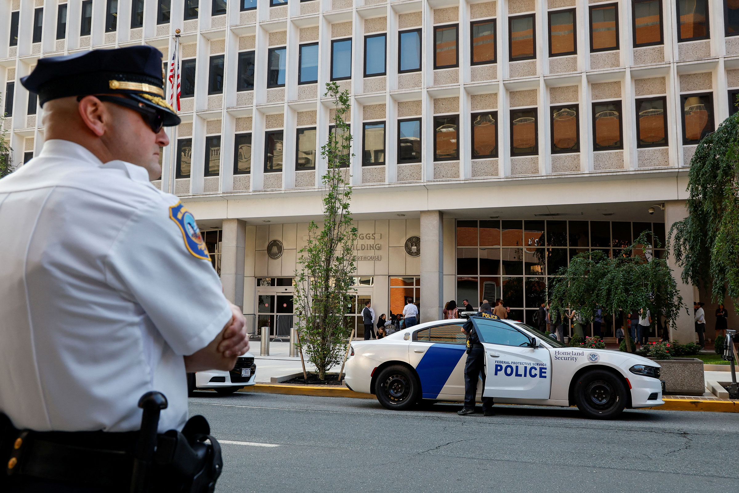 An officer looks on as law enforcement officers secure the area at federal court in Wilmington, Delaware, on July 26. 