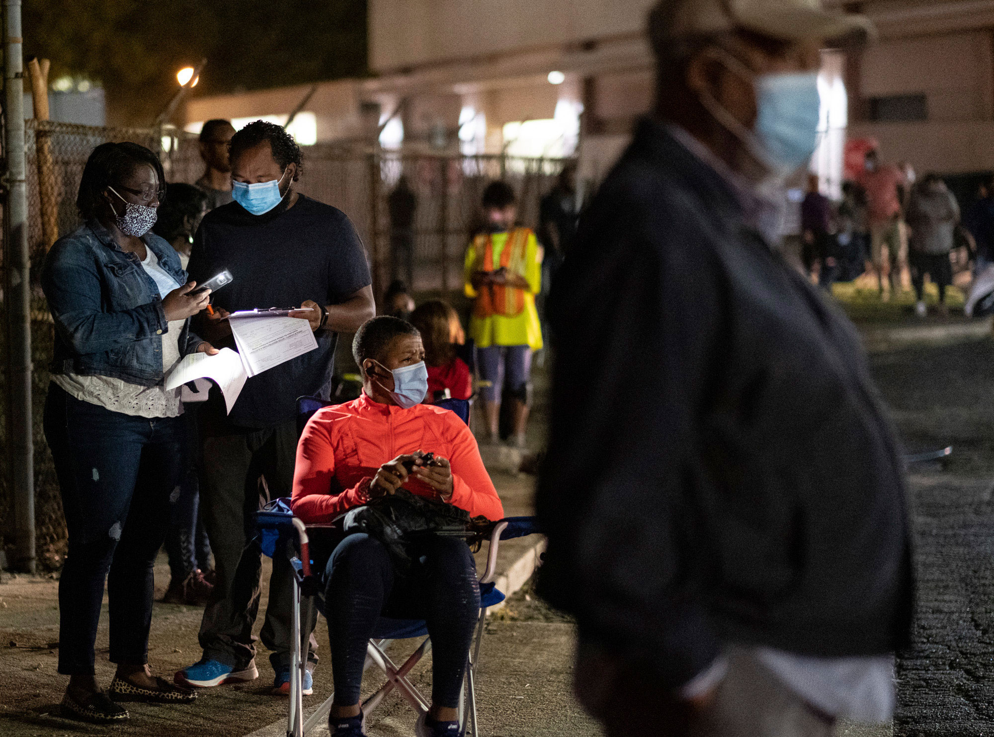 People in Decatur, Georgia, fill out a pre-registration form while waiting in line to vote on October 12.