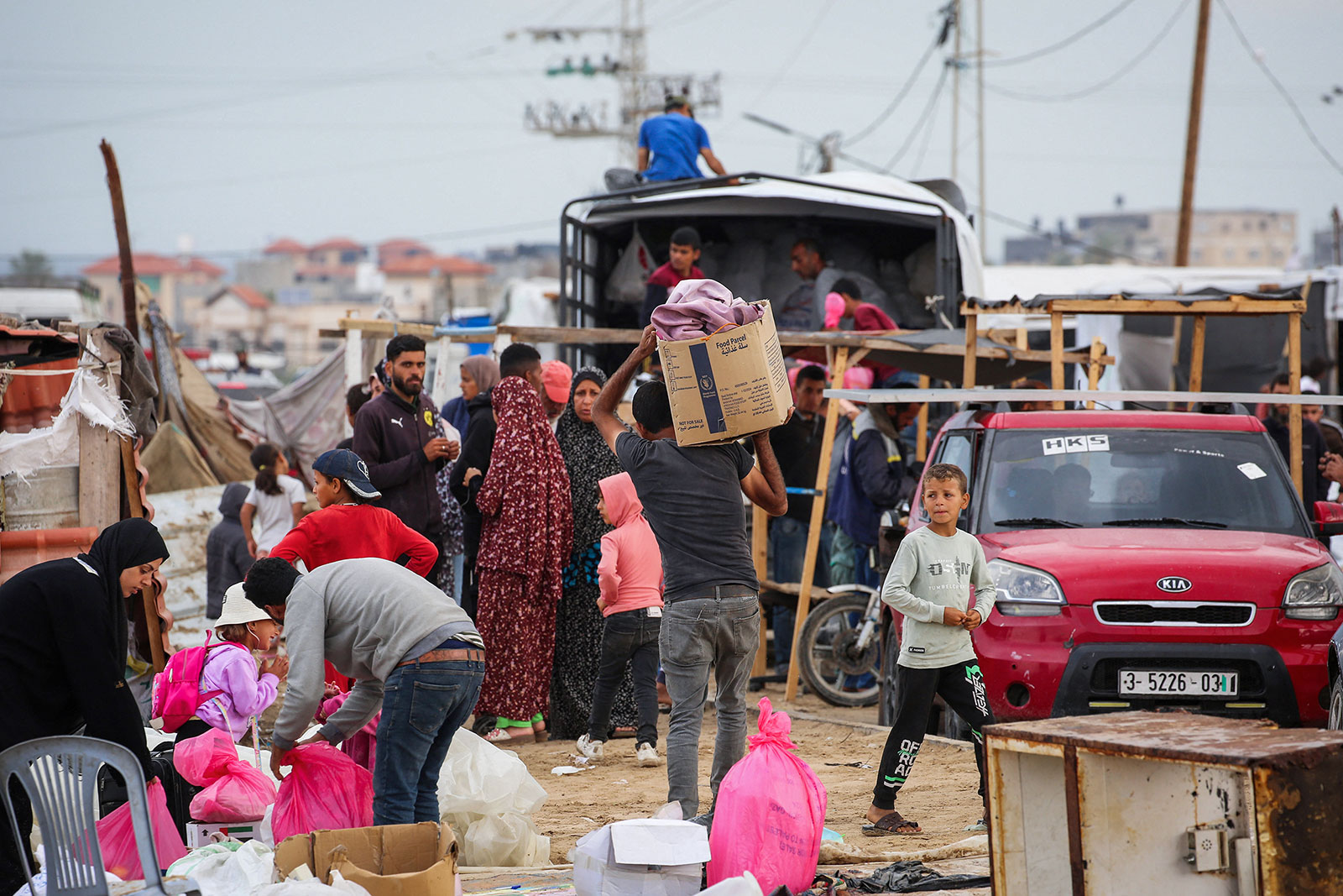 Palestinians pack their belongings as they prepare to flee Rafah in southern Gaza on Monday, May 13.