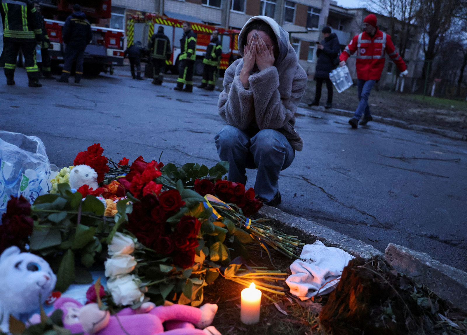 A woman cries next to a memorial for victims near the site of the helicopter crash in Brovary on Wednesday. 