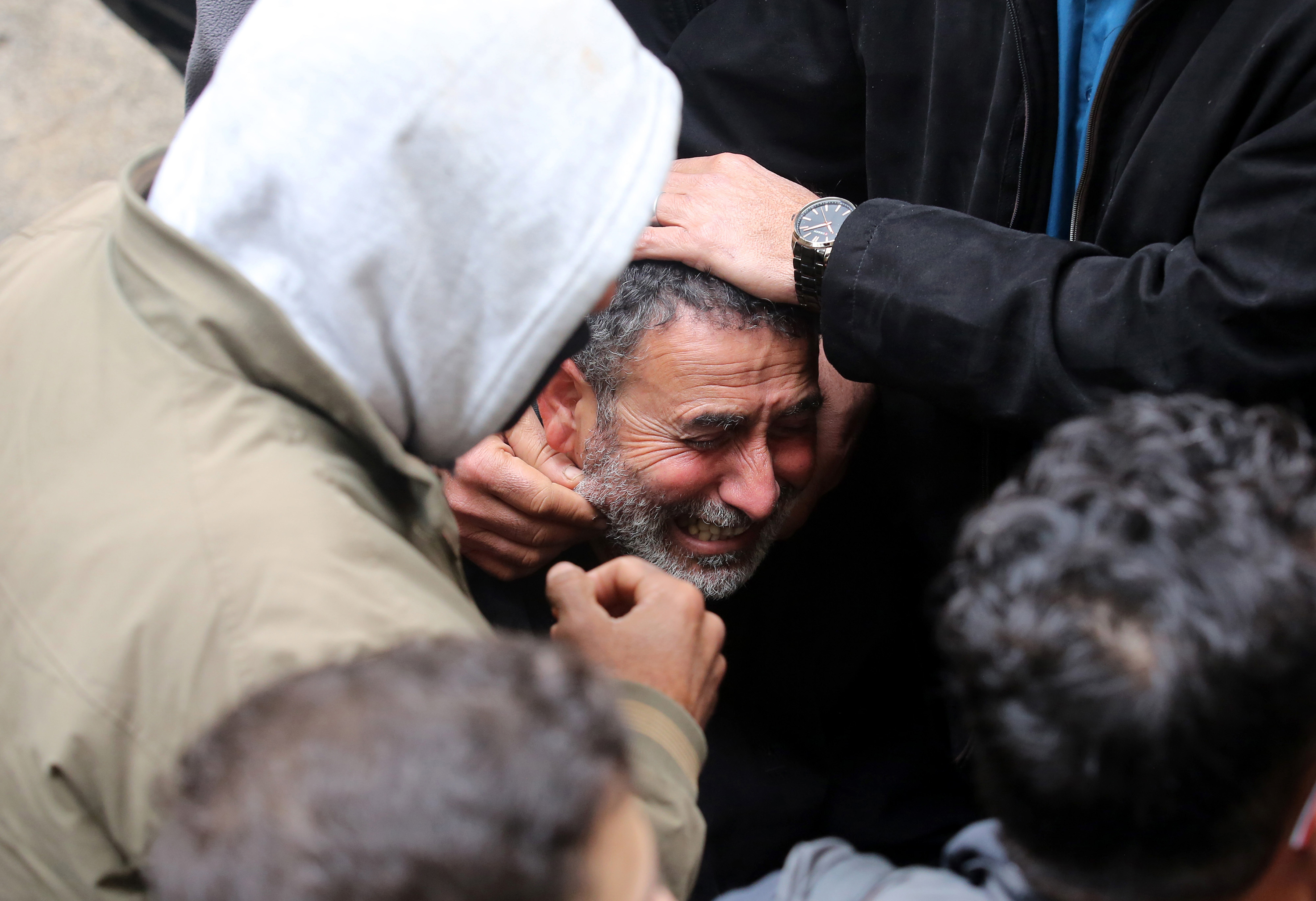 A man mourns as people attend the funeral ceremony of 3 Palestinians, killed during the Israeli raid into the Ibn Sina Hospital in Jenin, West Bank on January 30.