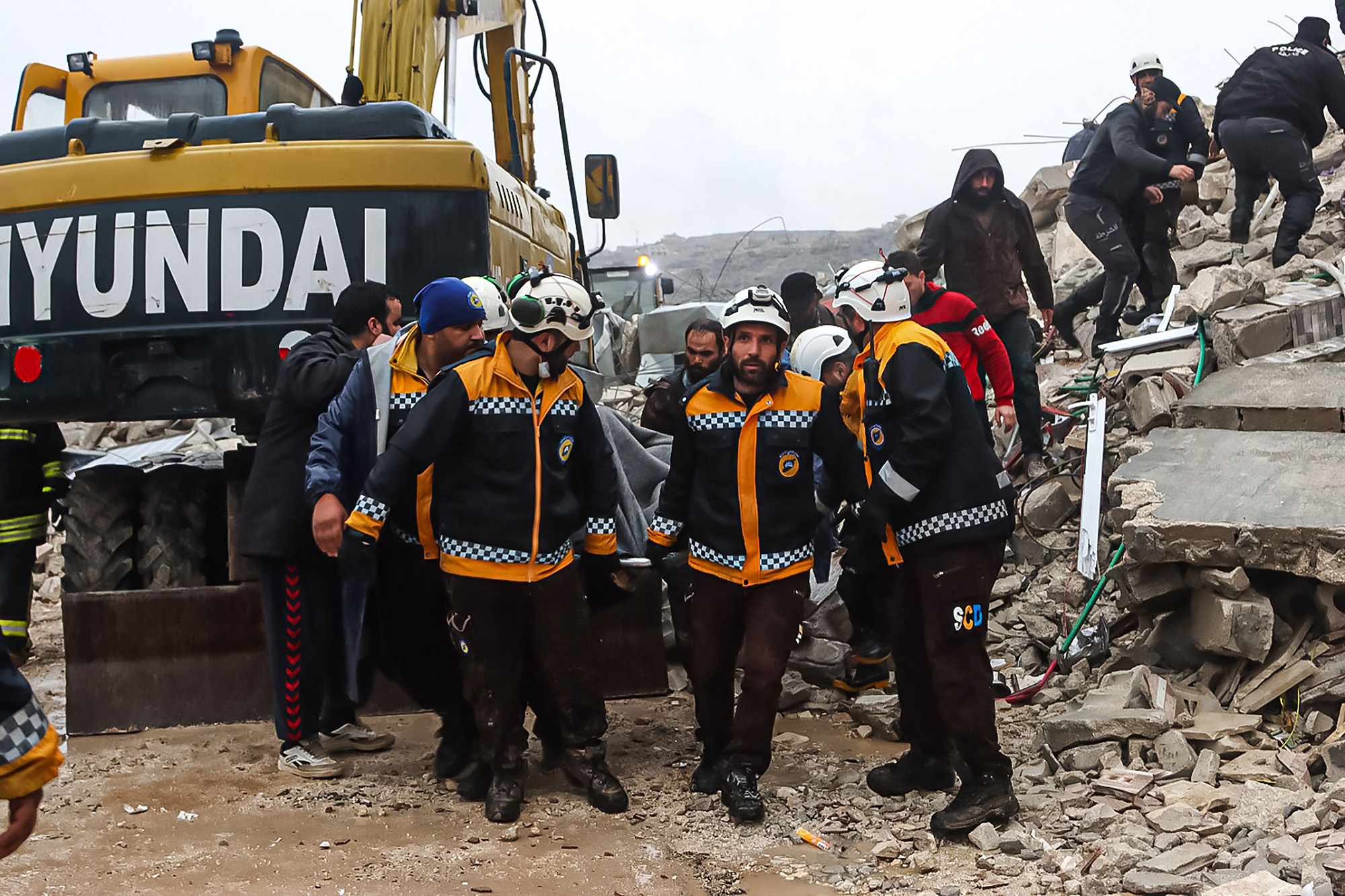 Rescue teams evacuate a victim pulled out of the rubble following an earthquake in Idlib, Syria, on February 6.